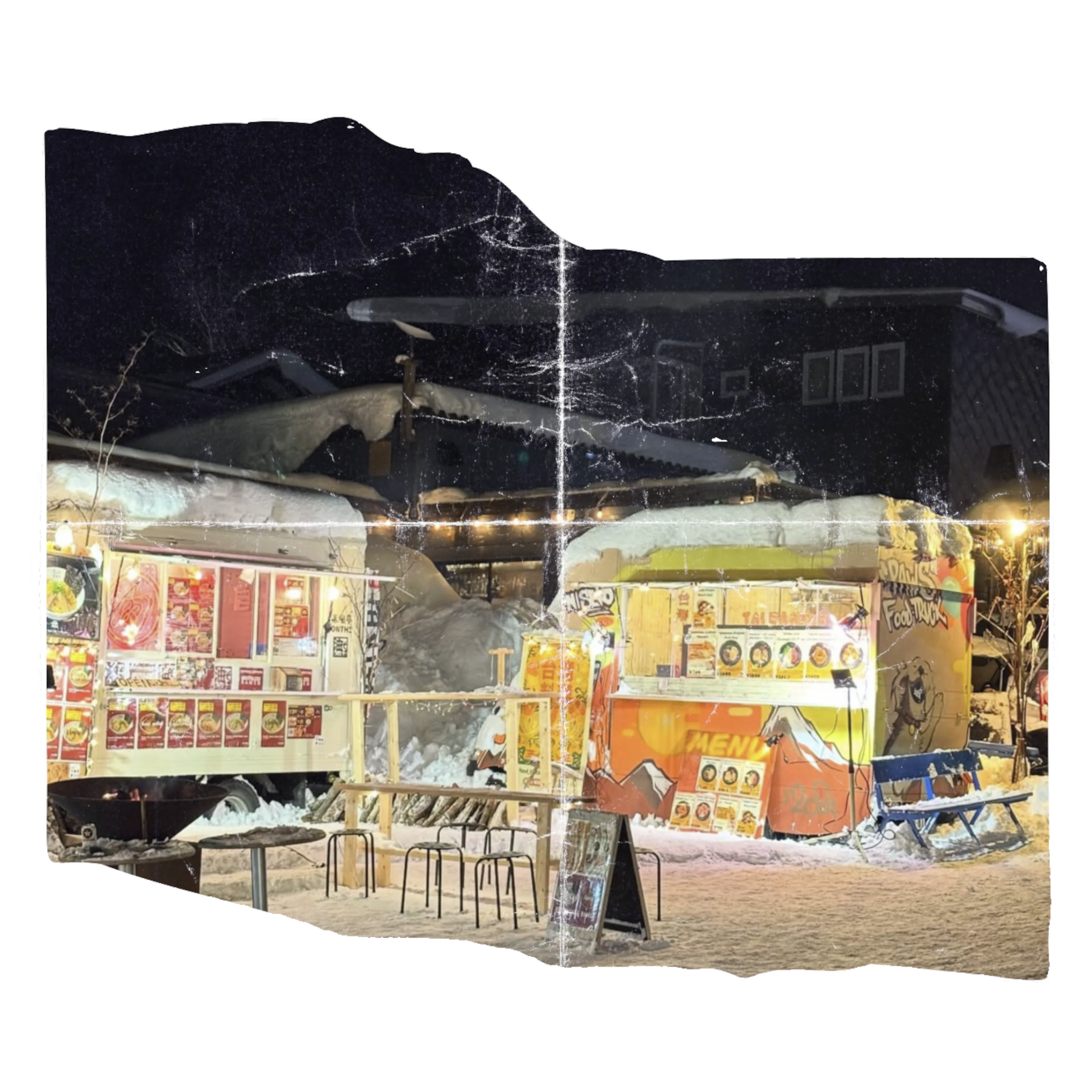Nighttime scene of a fast food restaurant with a damaged, broken, and charred sign, surrounded by debris, chairs, and tables outside.
