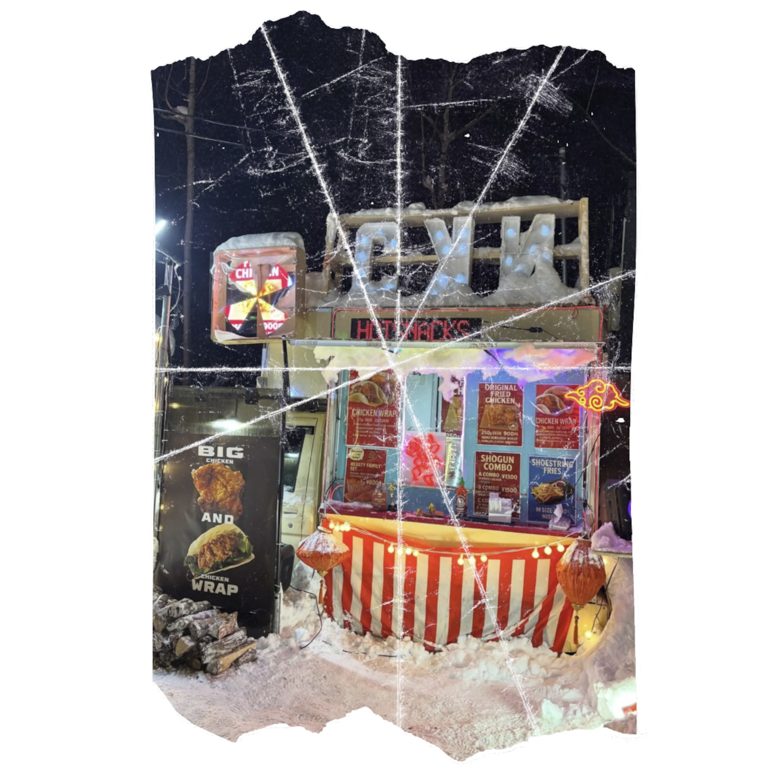 A glass display case filled with fast food items, including fried chicken, at night. The background is decorated with string lights, and there is a sign that says 'HUNGRY' and other food advertisements. The display appears to be icy or frosted at the bottom.