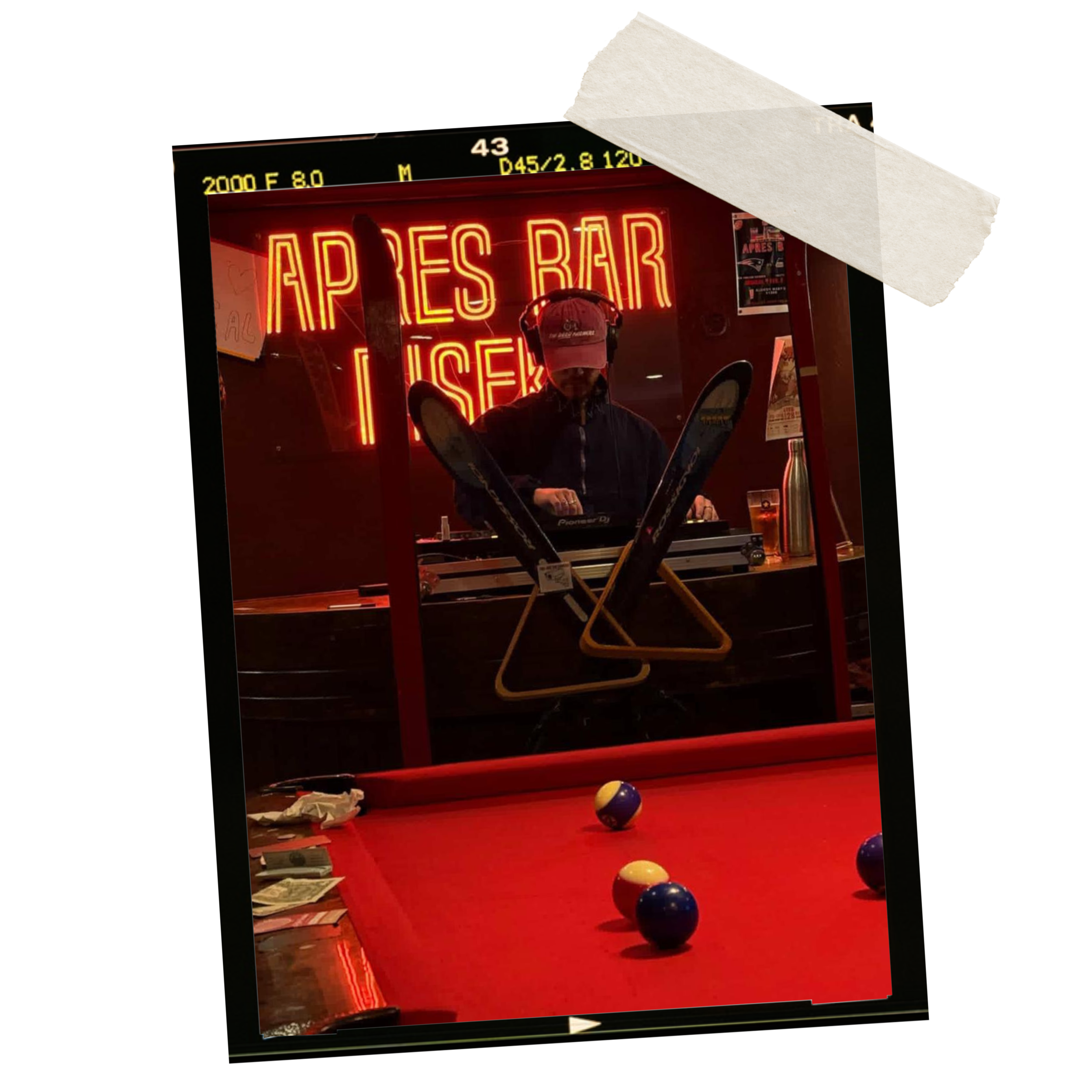 Indoor scene featuring a neon sign reading 'APRES BAR' behind a person in a black jacket and cap, with billiard balls scattered on a red pool table.