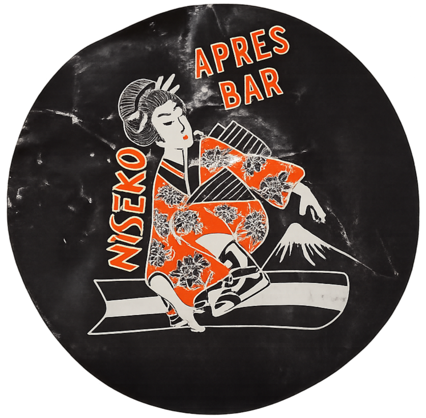 A black circular sign with a vintage style illustration of a woman in a kimono, holding a bowl, with Mount Fuji in the background. The sign reads "NISEKO" on the left and "APRES BAR" at the top in red and orange letters.
