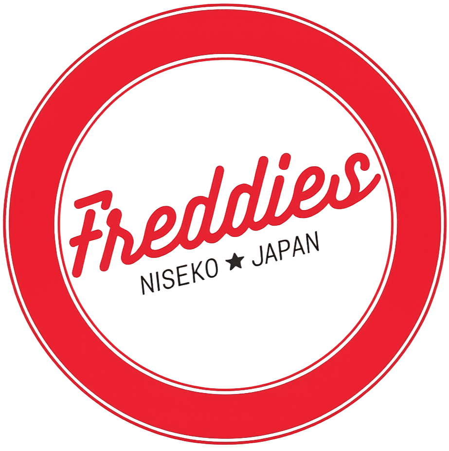 Red and white circular logo for Freddies, Niseiko Japan
