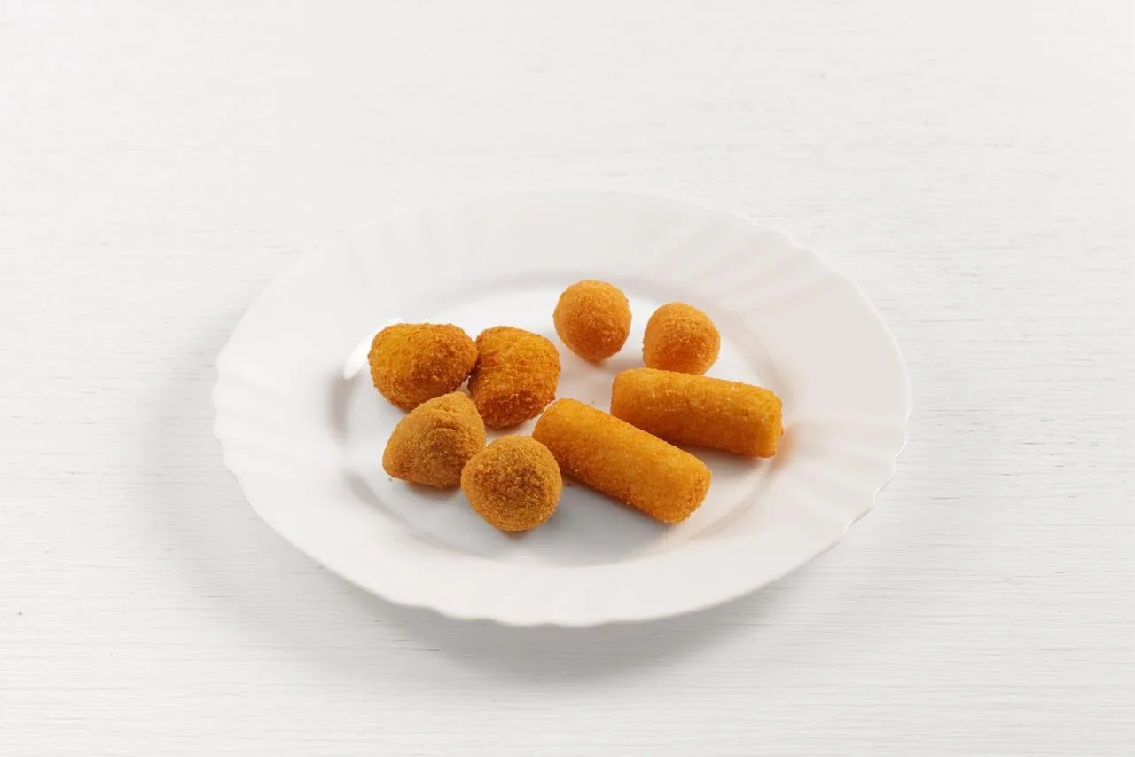 Piatti di cibo fritto su un piatto bianco su sfondo bianco