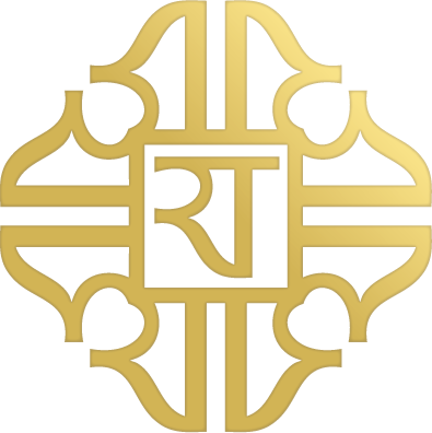 A gold-colored, ornate, symmetrical design with a central letter 'J', featuring intricate patterns and blue and gray accents.