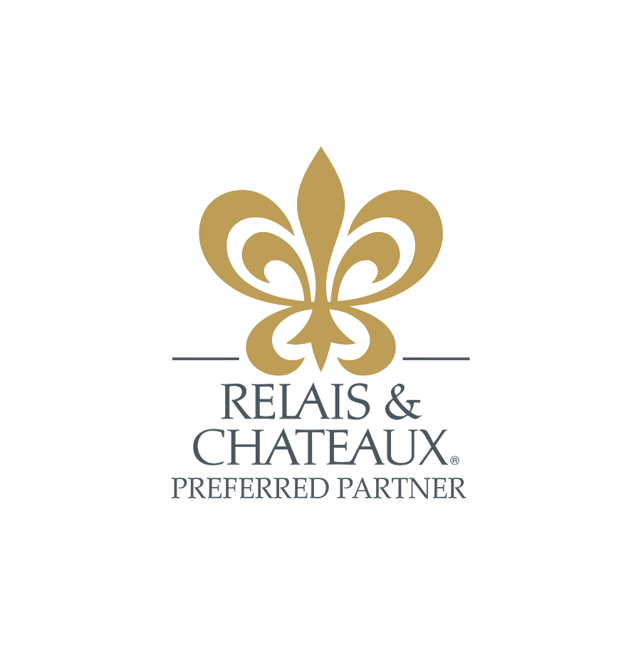 Rebhais & Chateaux logo with a gold fleur-de-lis symbol and text that reads "Rebhais & Chateaux Preferred Partner" on a white background.