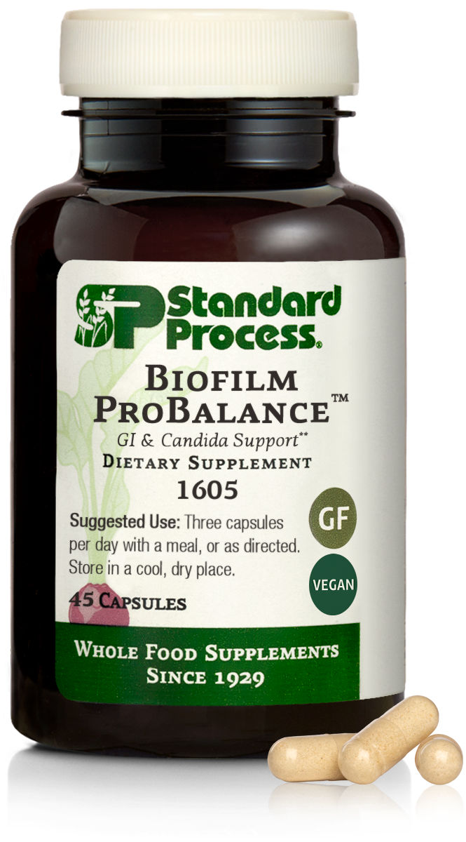 A bottle of Standard Process Biofilm ProBalance dietary supplement with capsules next to it.