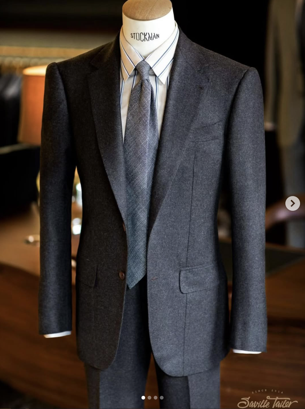 A bespoke dark grey suit.