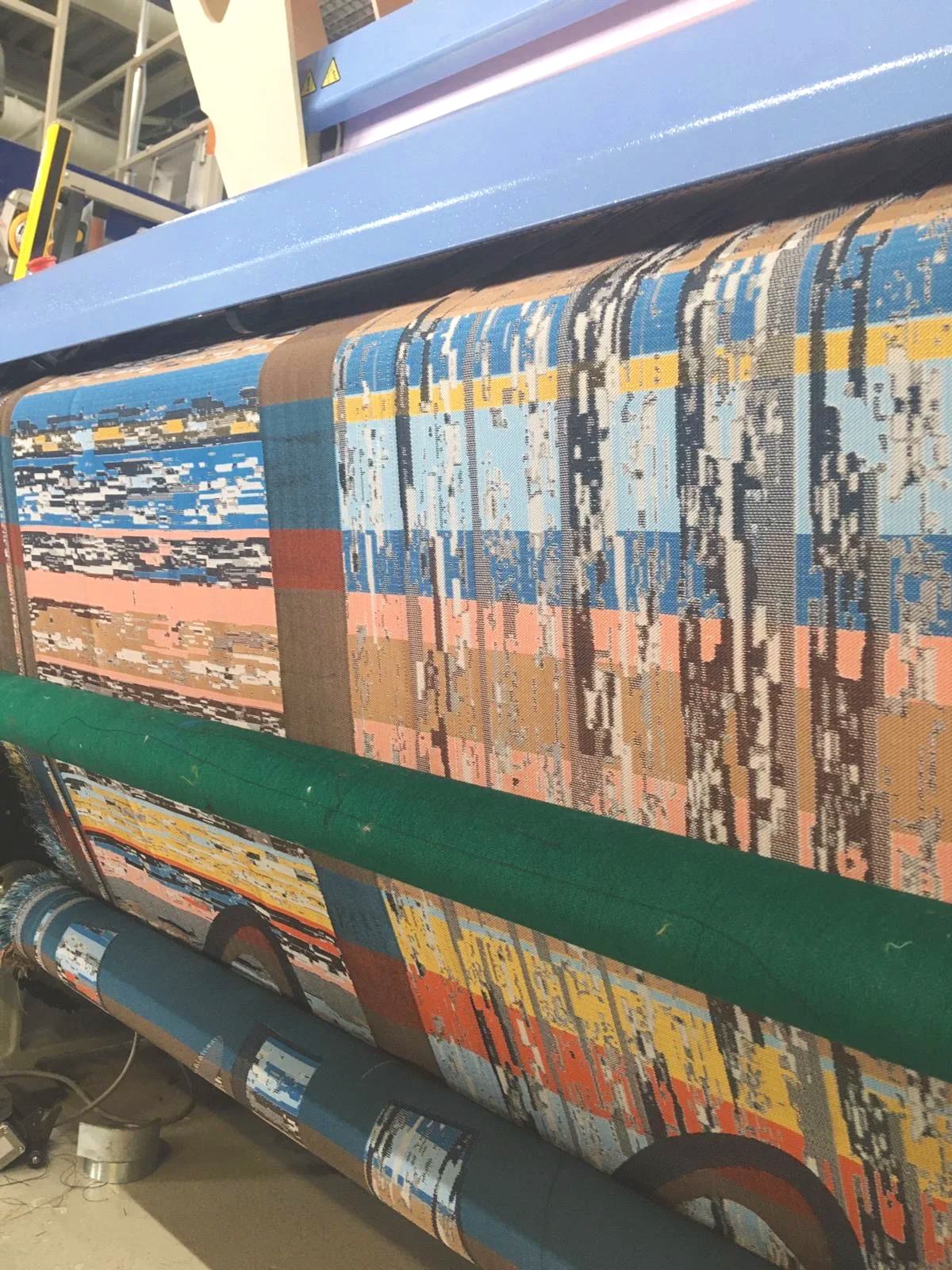 Zero Waste Weavers - 3 pairs of Sediment Trouser designs being woven on the loom. Textile-form Woven 100% recyclable polyester with heat reactive yarn for adaptive fit