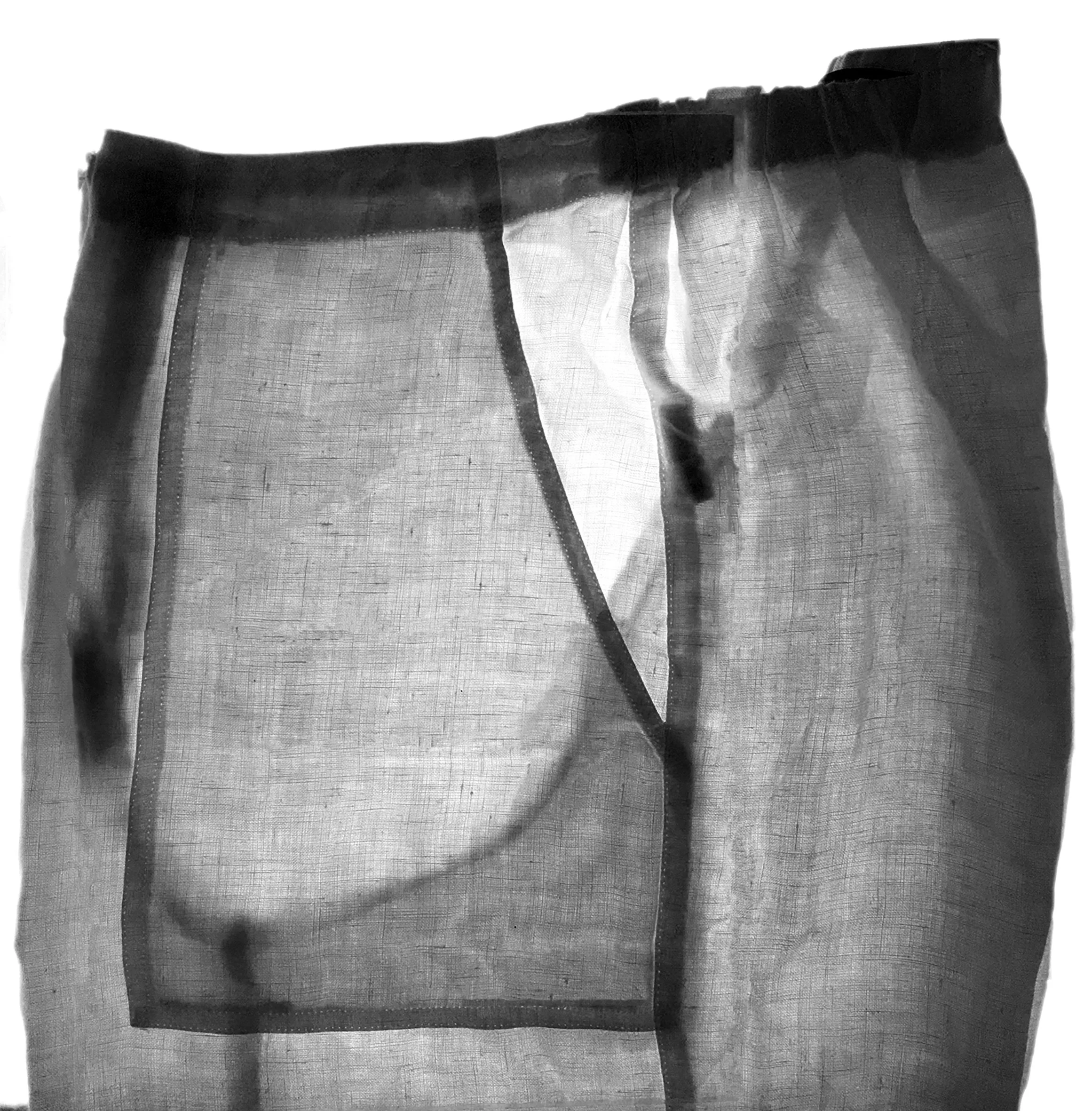 A light-box reveals the layers that make the folded form of a conventionally made trouser that can be translated into woven layers