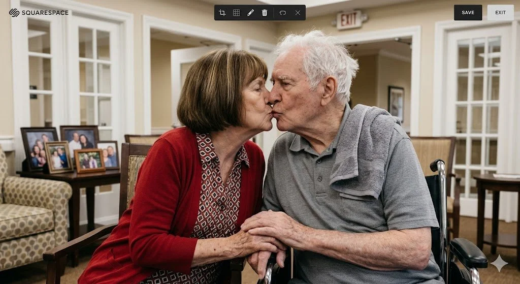 An elderly couple sharing a tender kiss in a comfortable living room decorated with family photos, representing compassionate geriatric care.