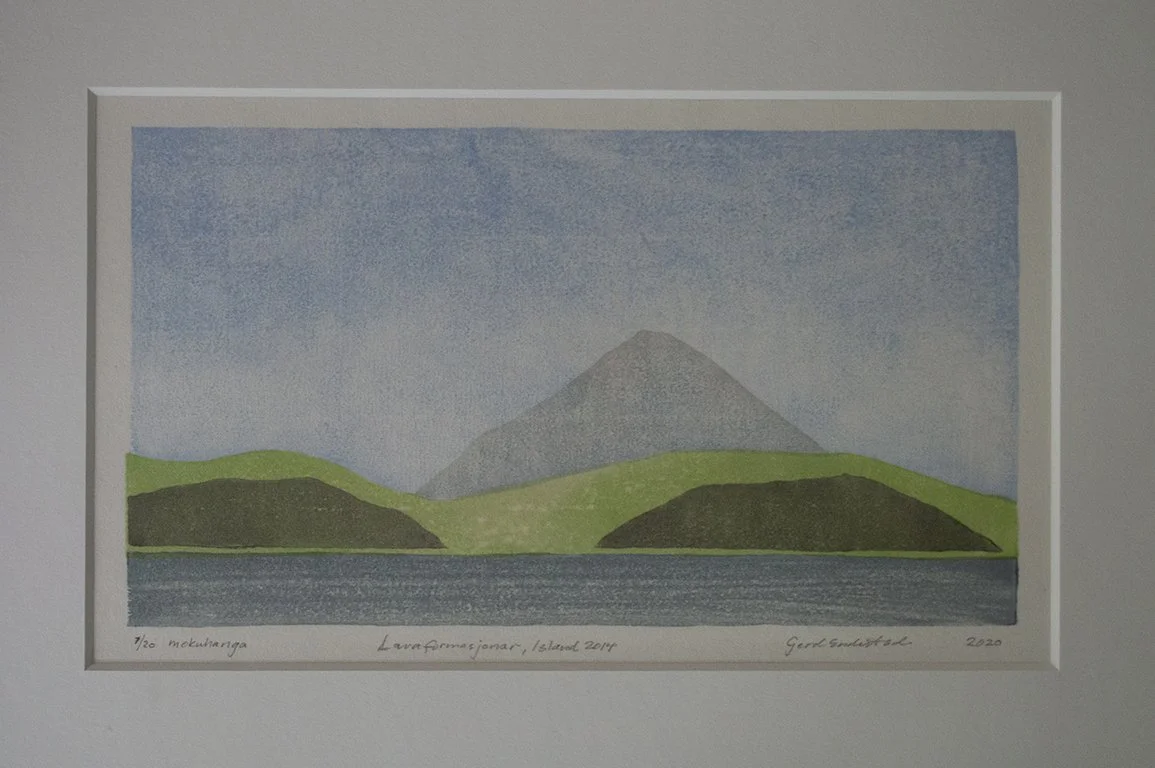 Japanese woodblock print; mokuhanga, of a mountain with green hills and a body of water in the foreground. Inspired by lava shaped landscape in Iceland.