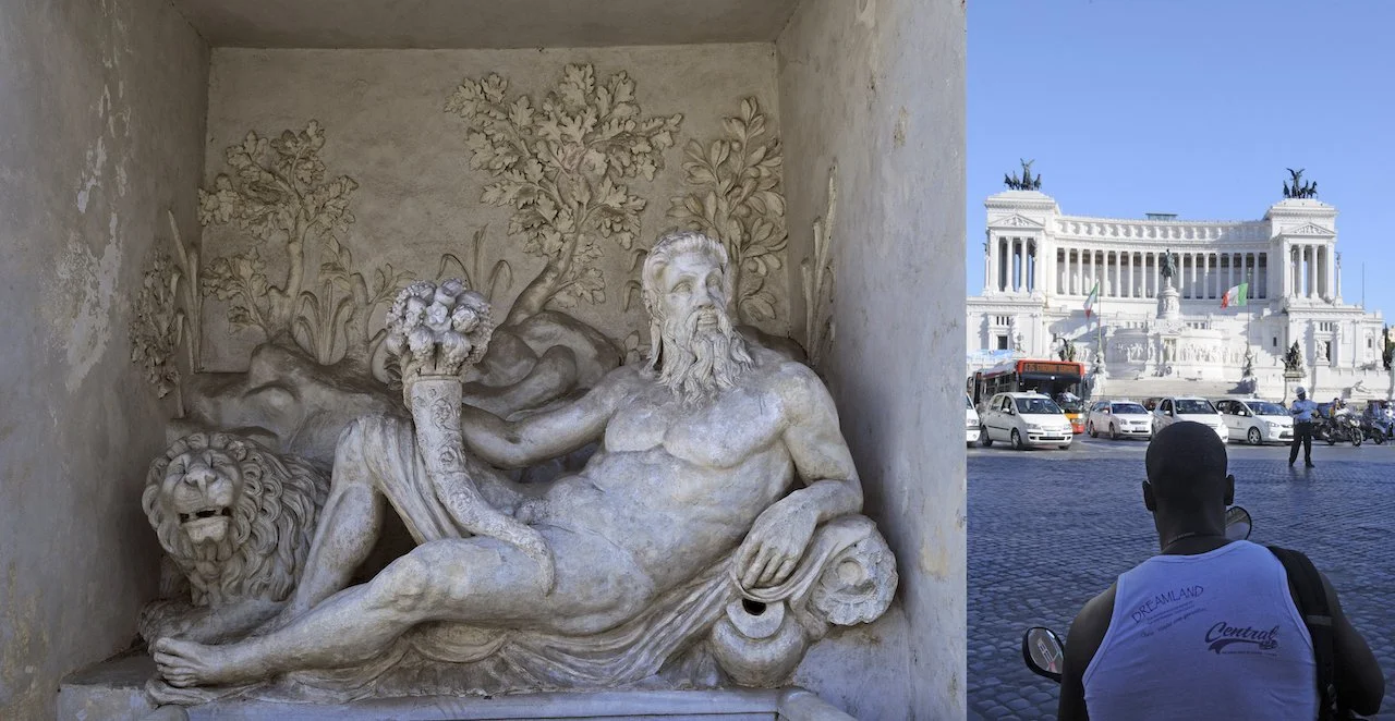 A marble sculpture of a reclining bearded man holding flowers, with a lion's head at his feet, set against a carved background of trees and plants; in the background, there's a view of a white monument with statues and many cars and people in front.