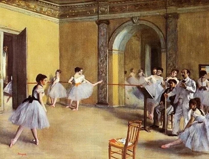 Ballet students practicing in a studio with a teacher at a piano, surrounded by mirrors and warm yellow walls.