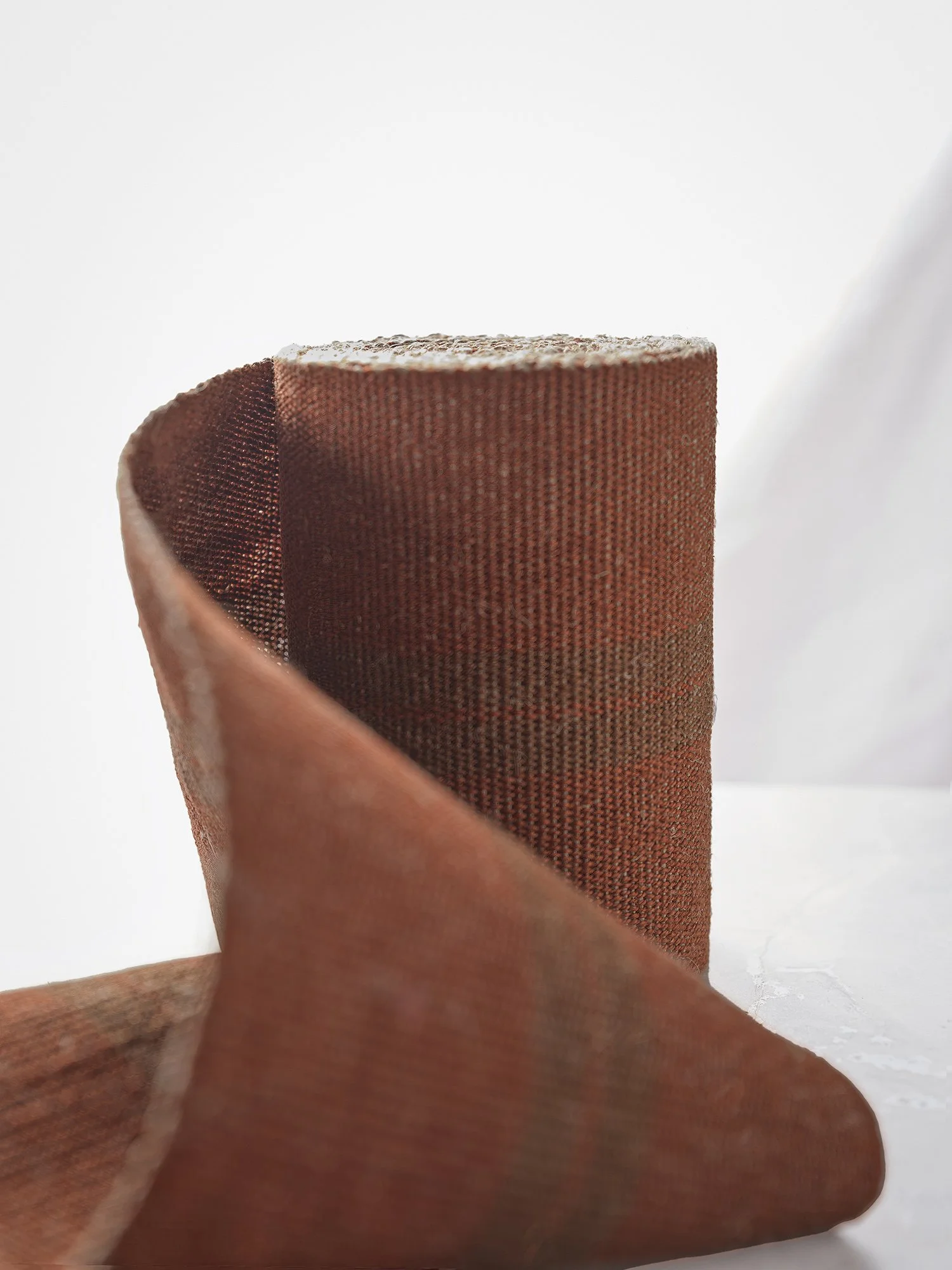 Soft view of Barred Copper handwoven linen tape trim in two shades of brown: oak and a shimmery copper in wide width.