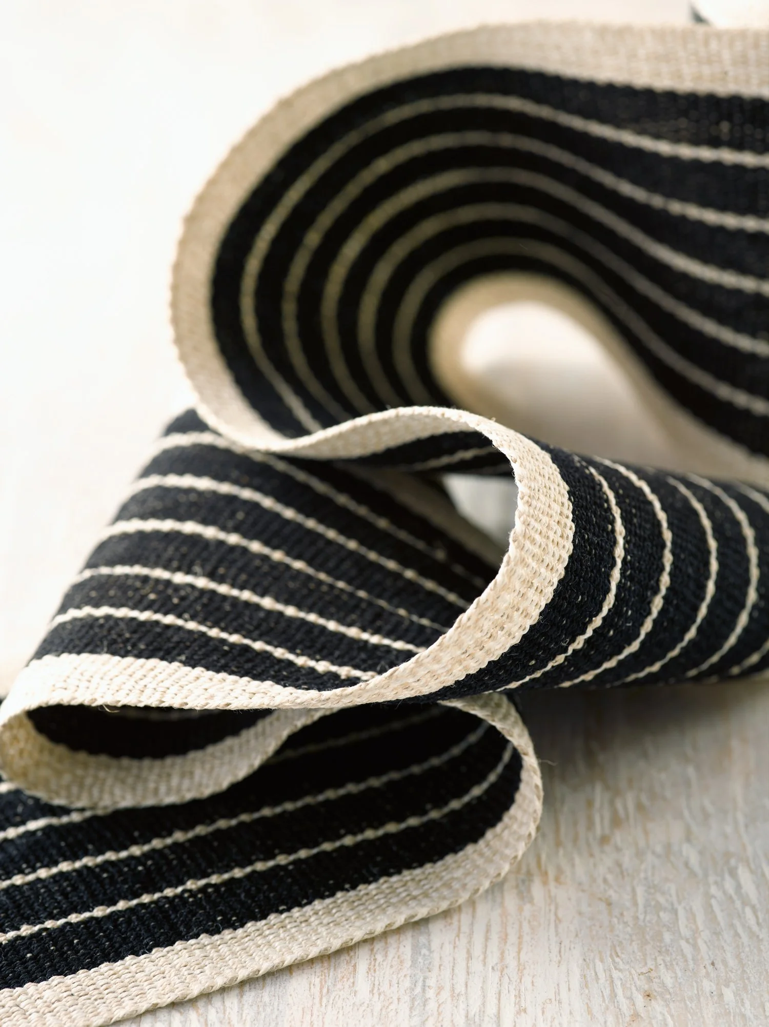 Old Tuxedo handwoven linen tape trim in black, ivory and cream in wide width.