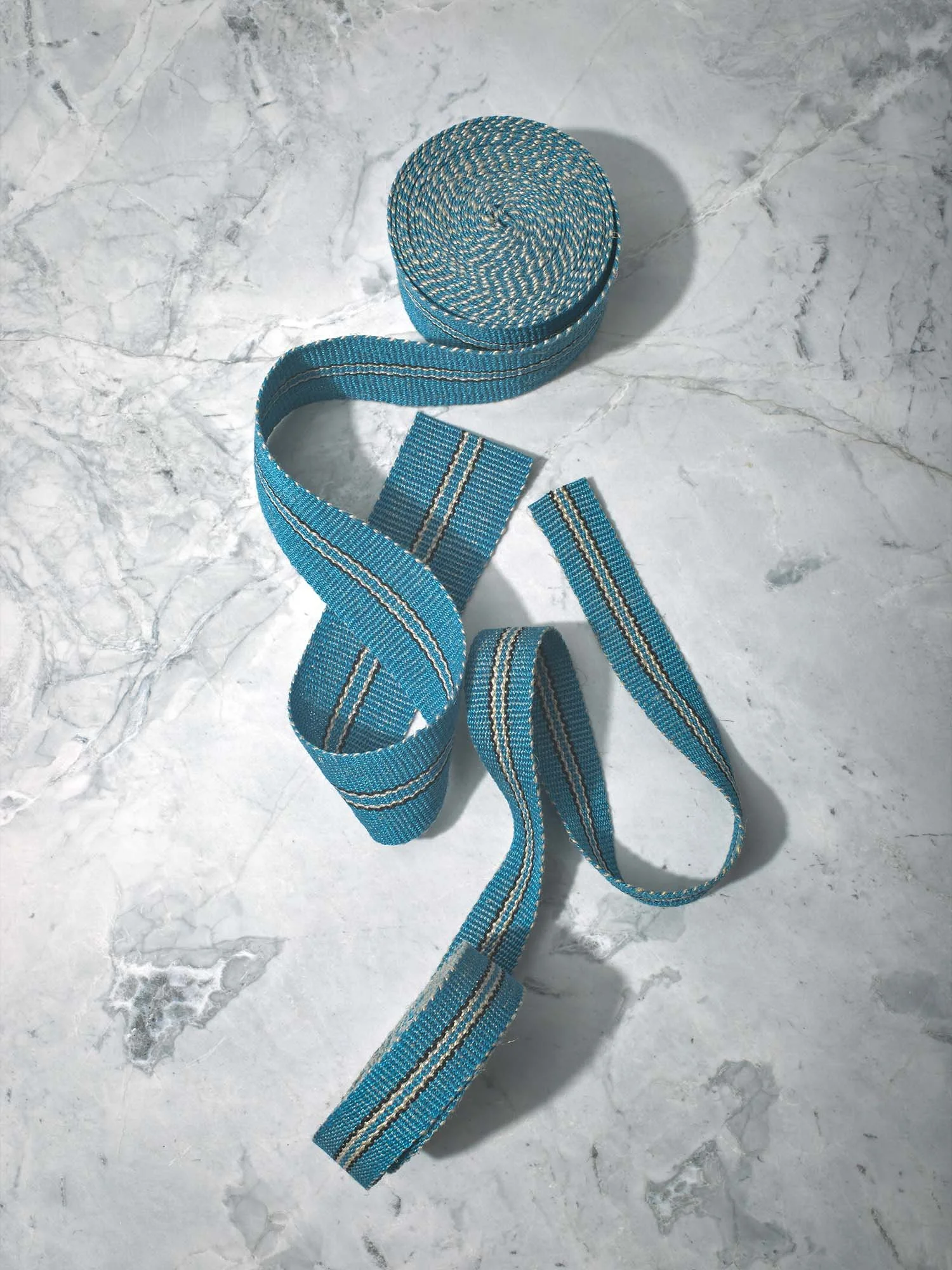 Intertwined Lysefjord handwoven linen tape trim in a cool fjord blue with pinstripes of black and flax in narrow and medium widths.