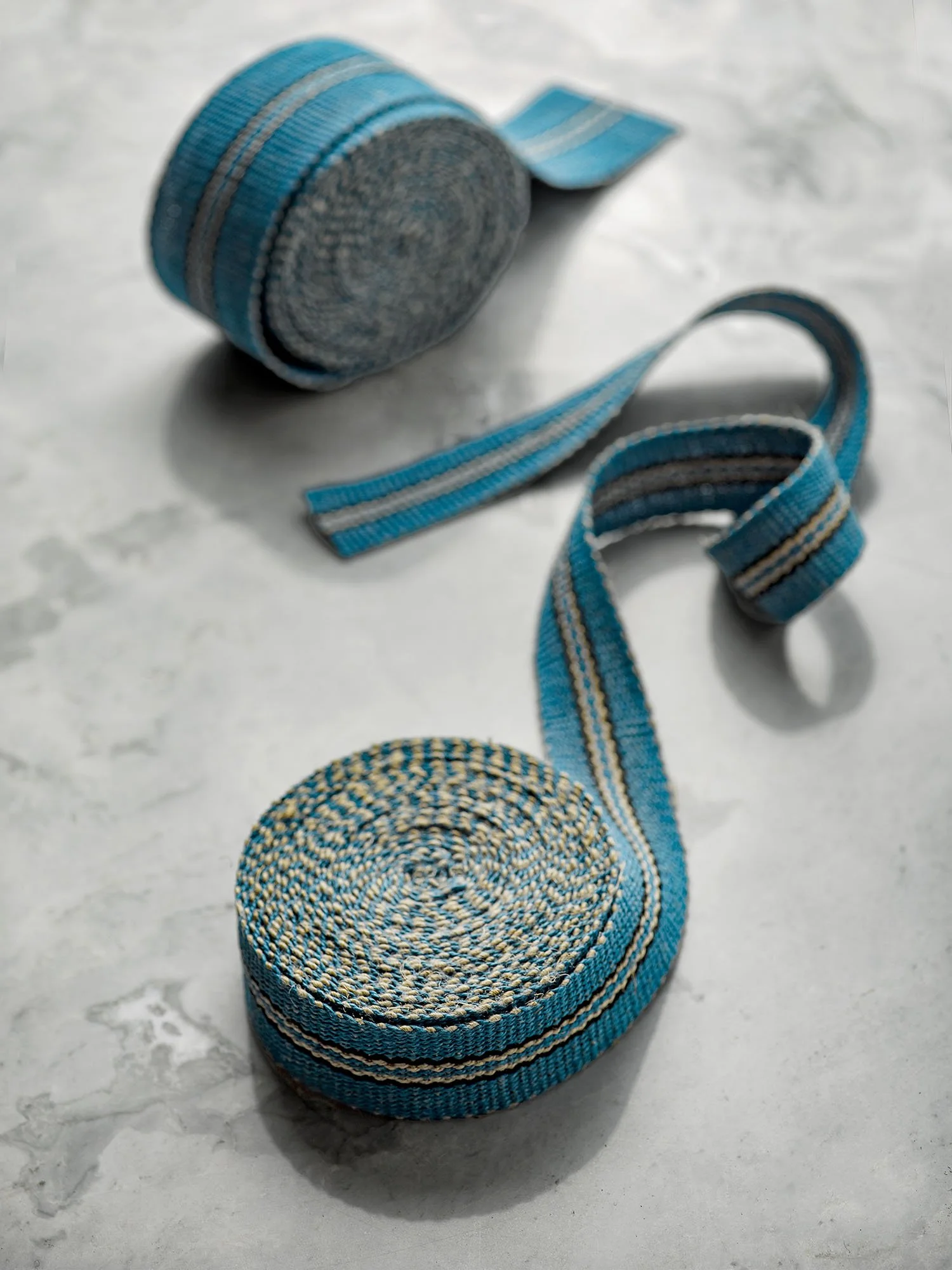 Lysefjord handwoven linen tape trim in a cool fjord blue with pinstripes of black and flax in narrow and medium widths.