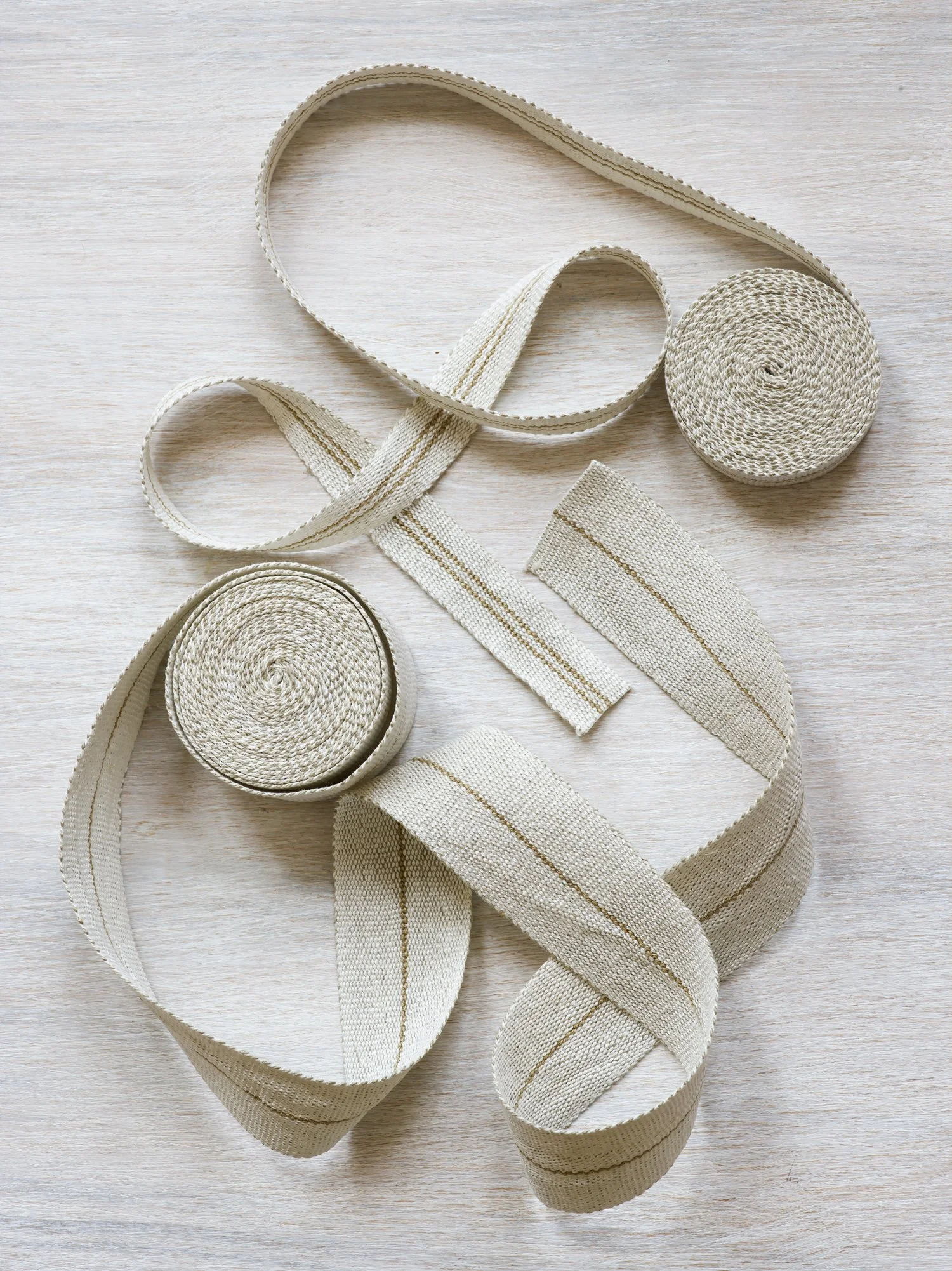 Modern Neutral II: Field Lines handwoven linen tape trim with gold lines on white fields in narrow and medium widths.