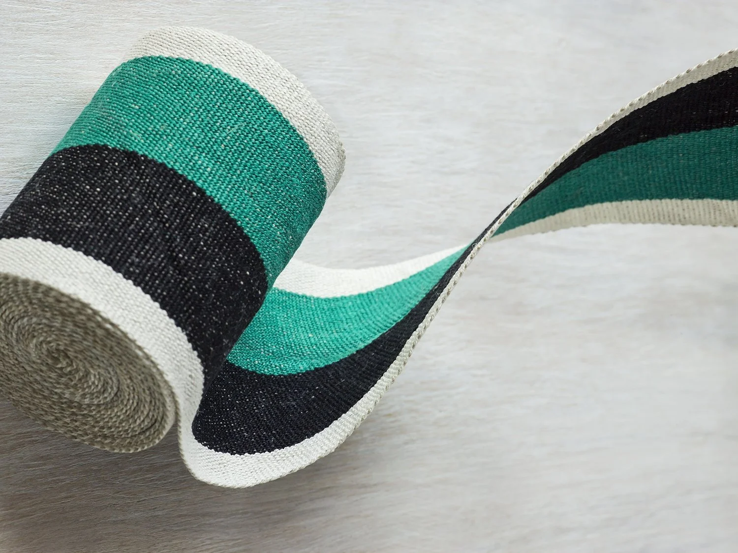 Dorothy handwoven linen tape trim in a bright emerald green, black and white in wide width.