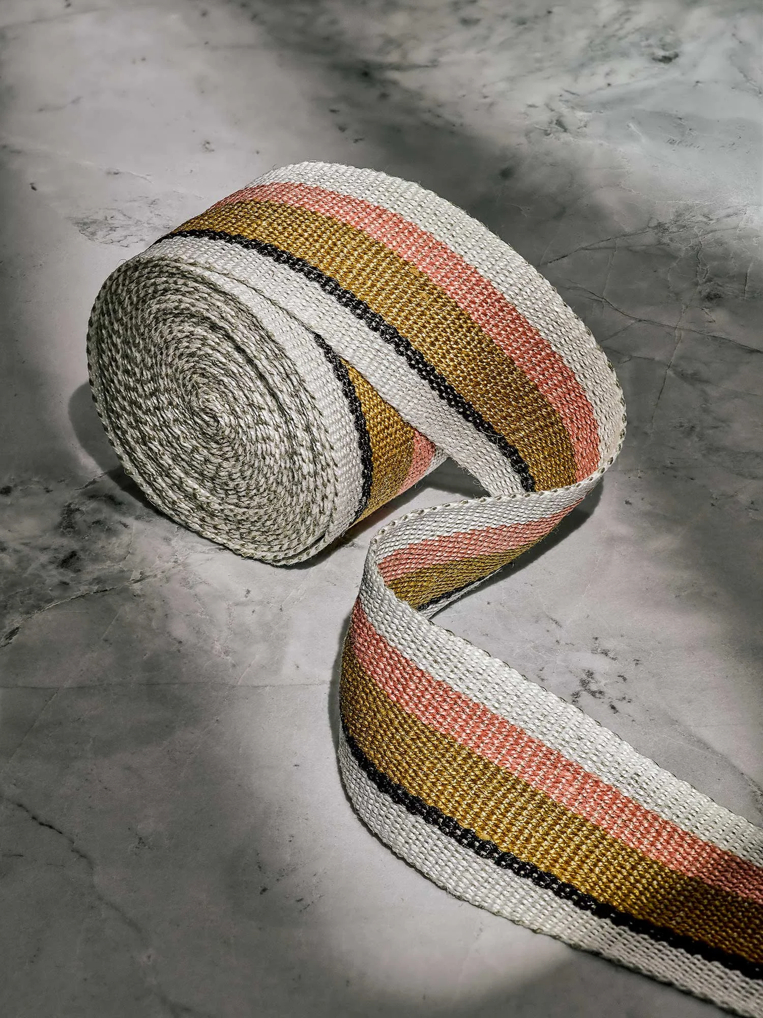 Anni handwoven linen tape trim in coral, bronze, black and white in medium width.