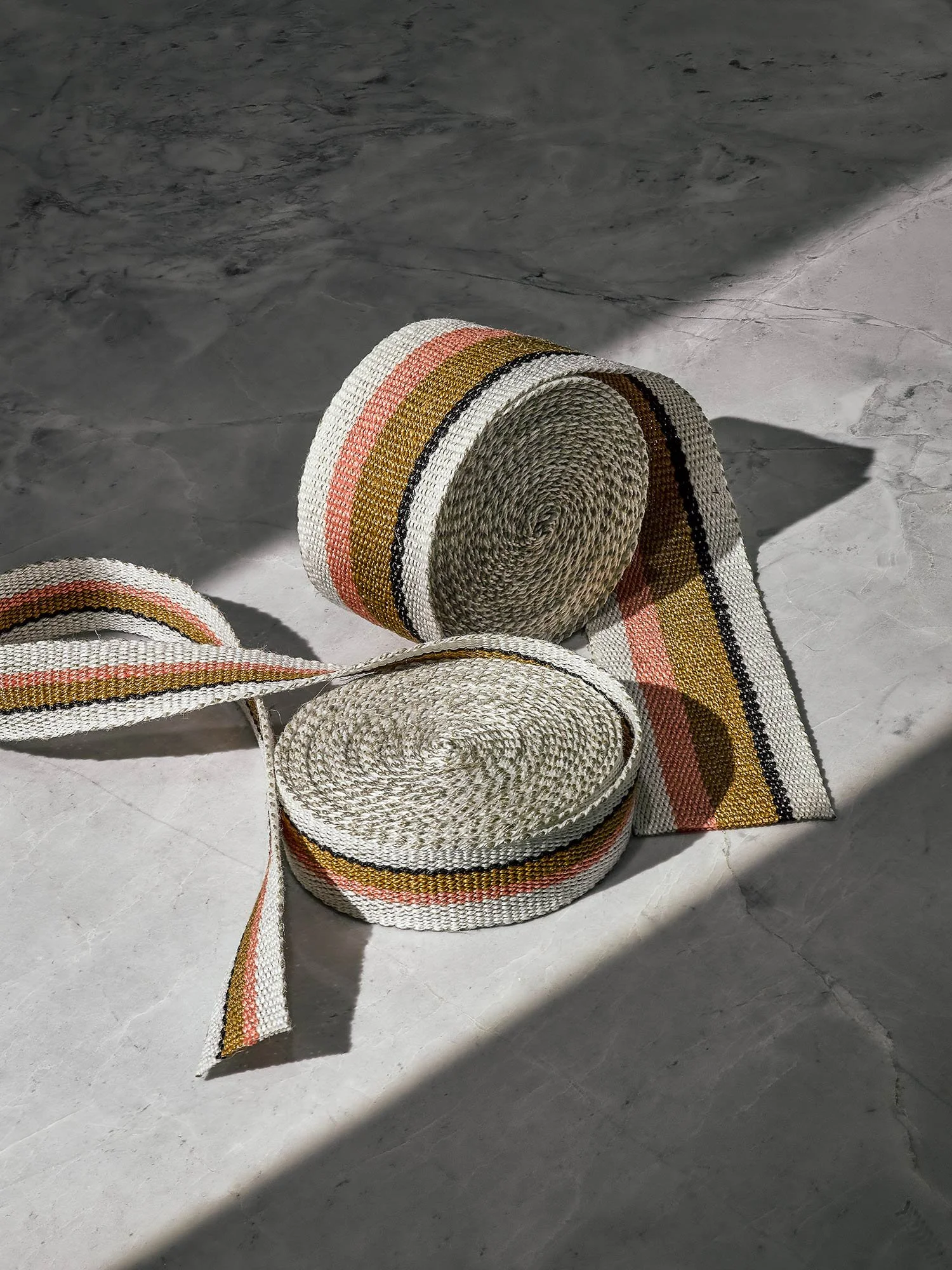 Anni handwoven linen tape trim in coral, bronze, black and white in narrow and medium widths.
