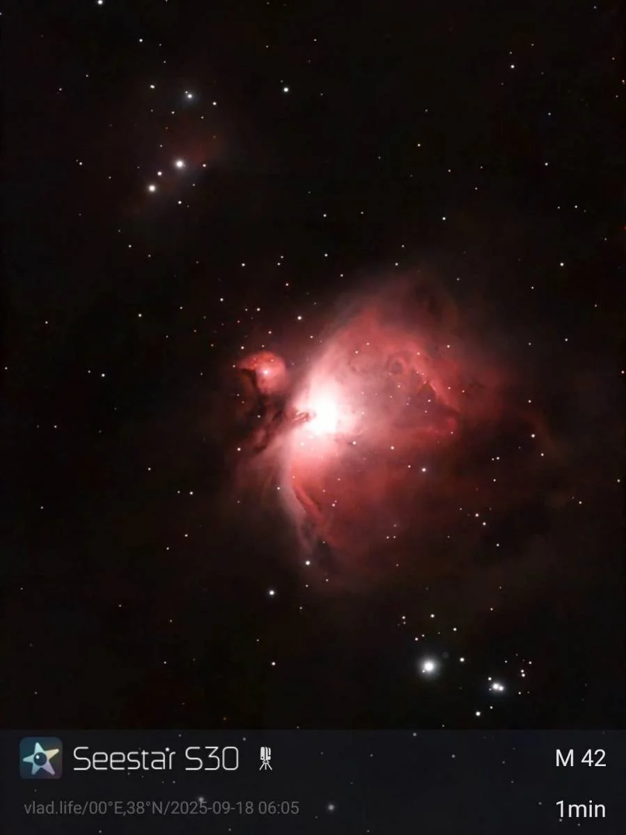 A photograph of outer space showing the Orion Nebula with numerous stars scattered in the background.