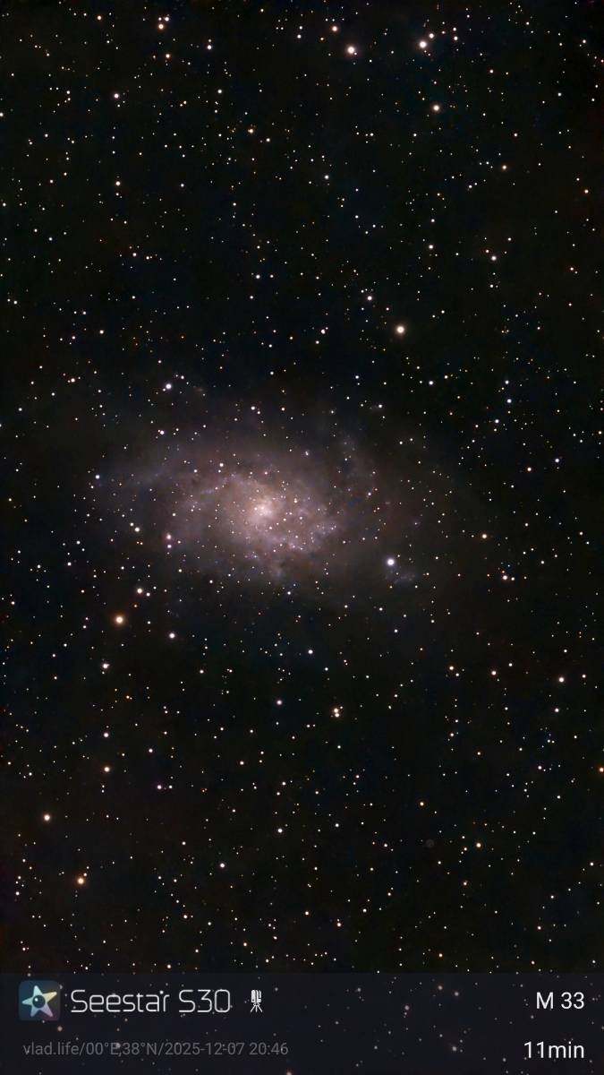 A photo of a starry night sky with a visible galaxy and numerous stars, taken from a space photography app.
