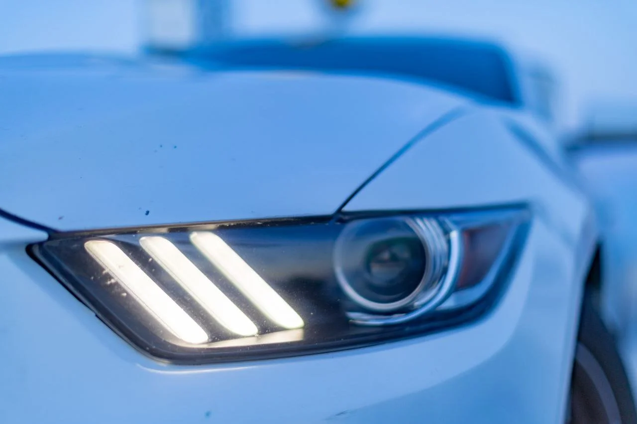 Close-up of a modern car's headlight with LED lights illuminated.