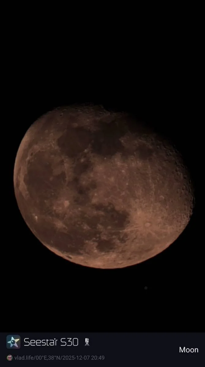 Photograph of the moon showing a detailed view of its surface with craters and maria, captured during a lunar observation. The image includes a label indicating the camera used, Seestar S30, and the date and time of the photograph.