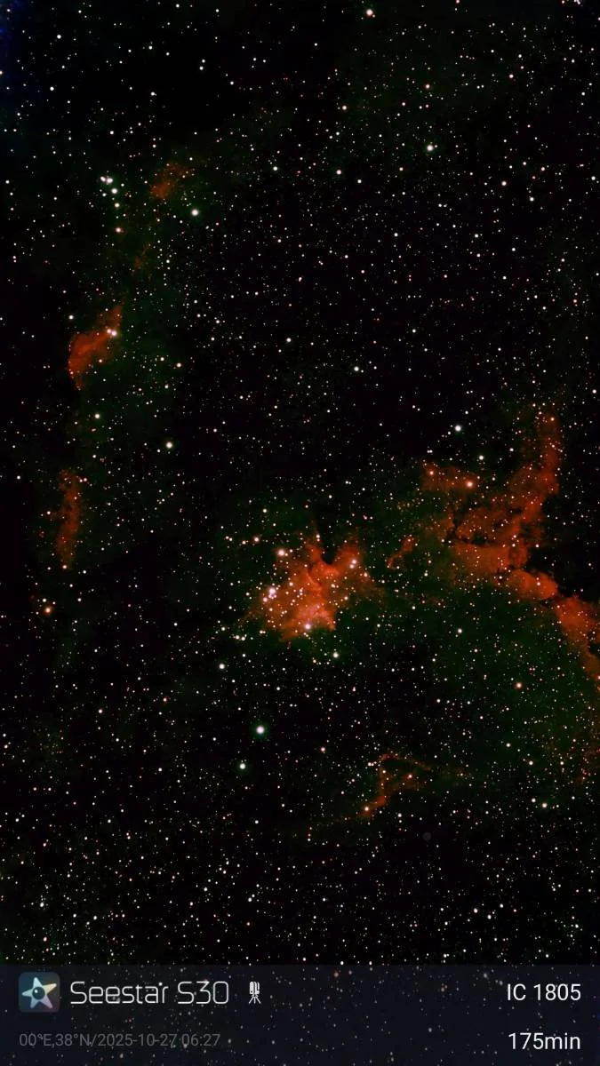 Image of outer space showing numerous stars and nebulae with a dark background.