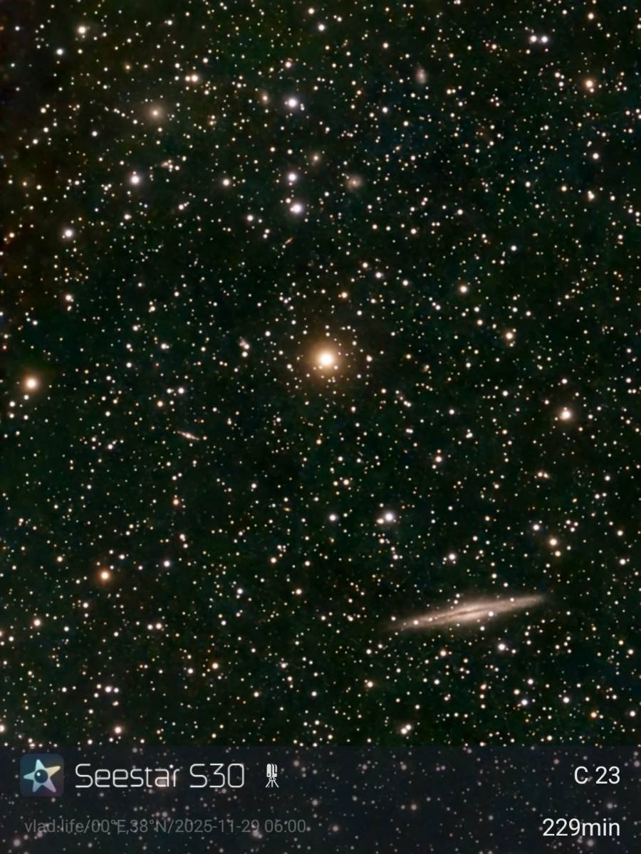 Image of a star-filled universe with numerous stars, galaxies, and celestial bodies, including a prominent galaxy towards the bottom right and a bright star in the center.