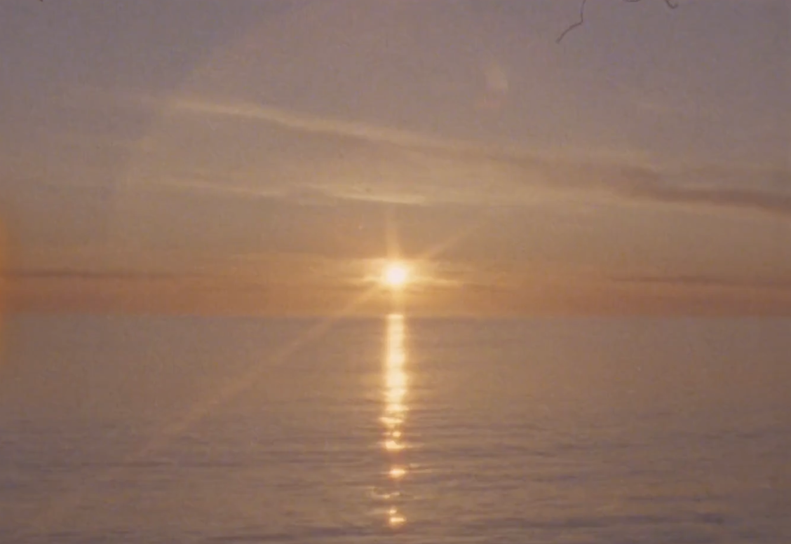 Sunset over the ocean with the sun reflecting on the water.