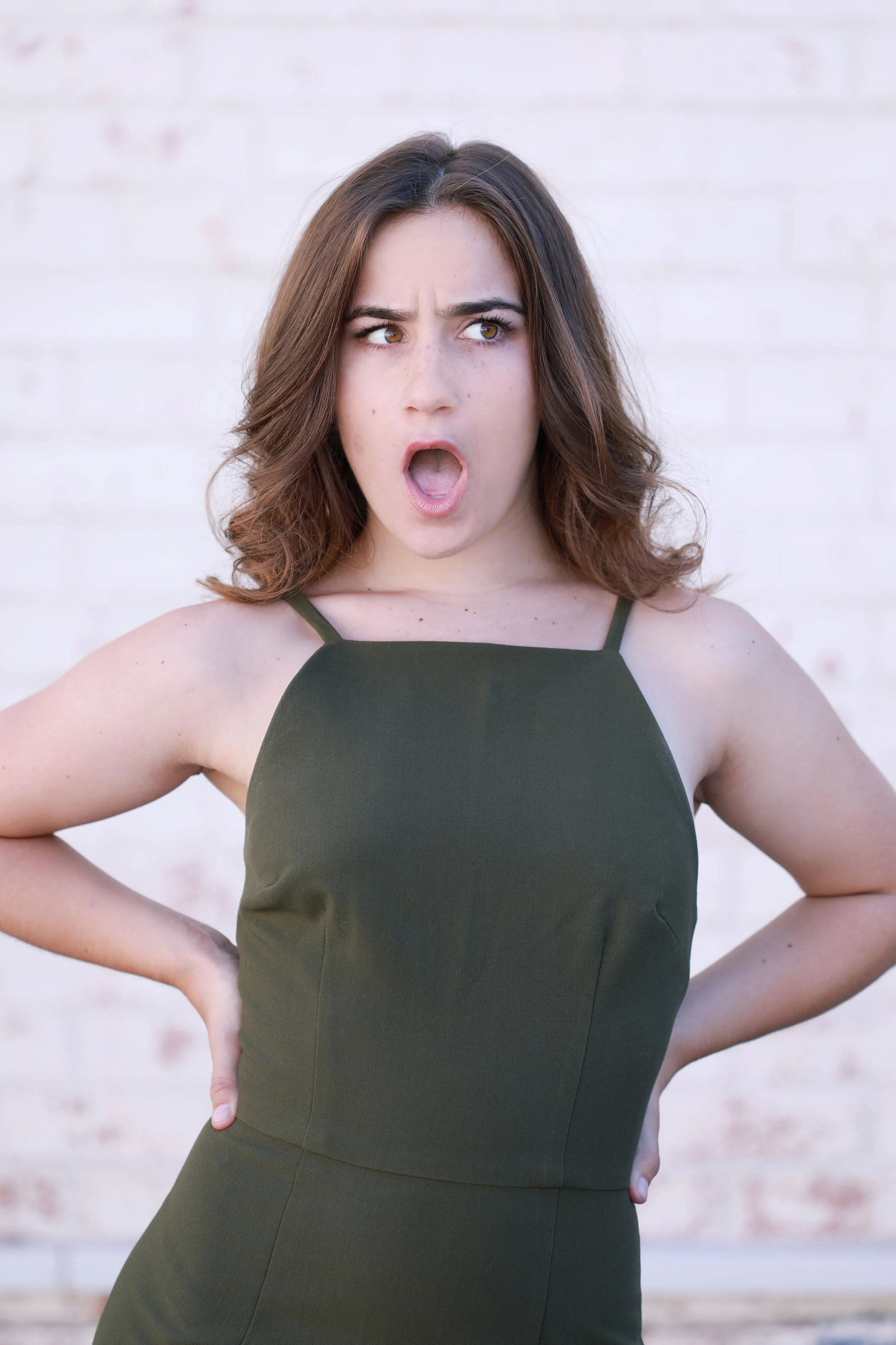 Cat Rojo 3/4 Headshot wearing a green halter dress with a sassy expression