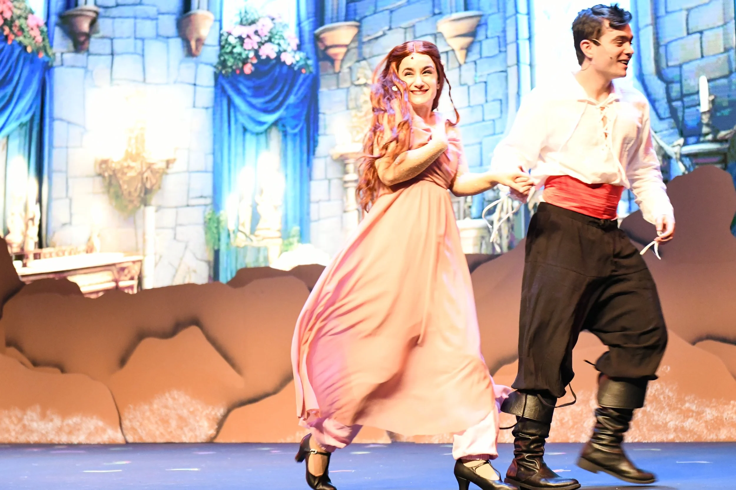 Cat Rojo as Ariel excitedly holding hands with Prince Eric