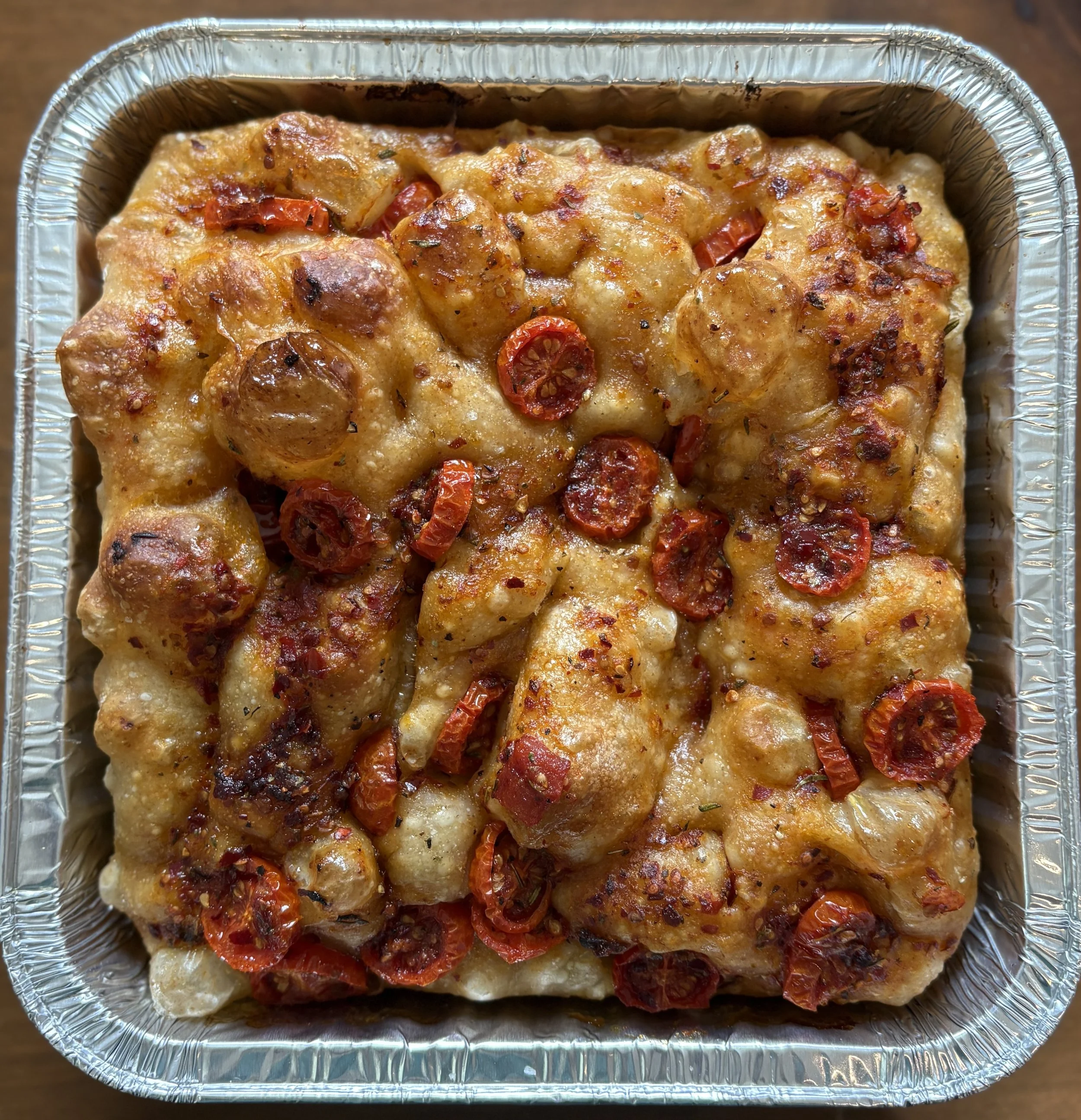 Southeast Sourdough's cherry tomatoes focaccia in a aluminum tray