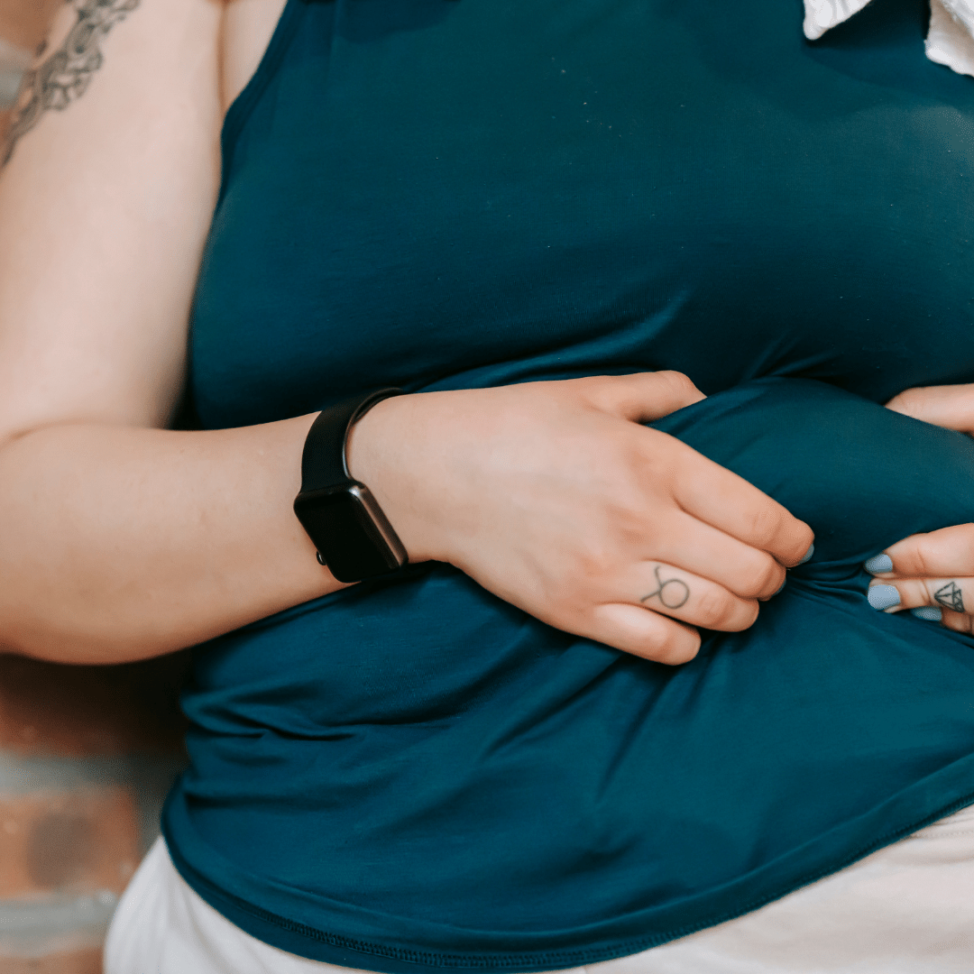 Person holding excess abdominal fat around their waist