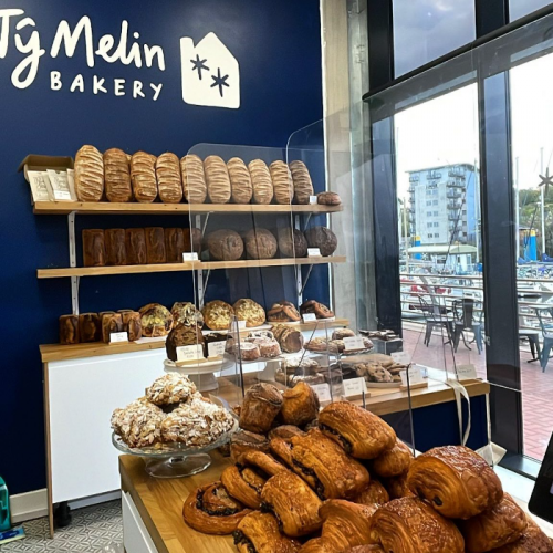 Display of various baked bread and pastries in Ty Melin bakery.