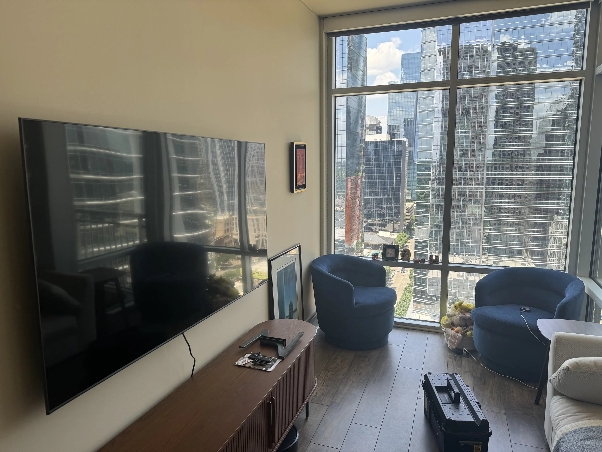 TV mounted in Downtown Austin high-rise condo with city skyline view