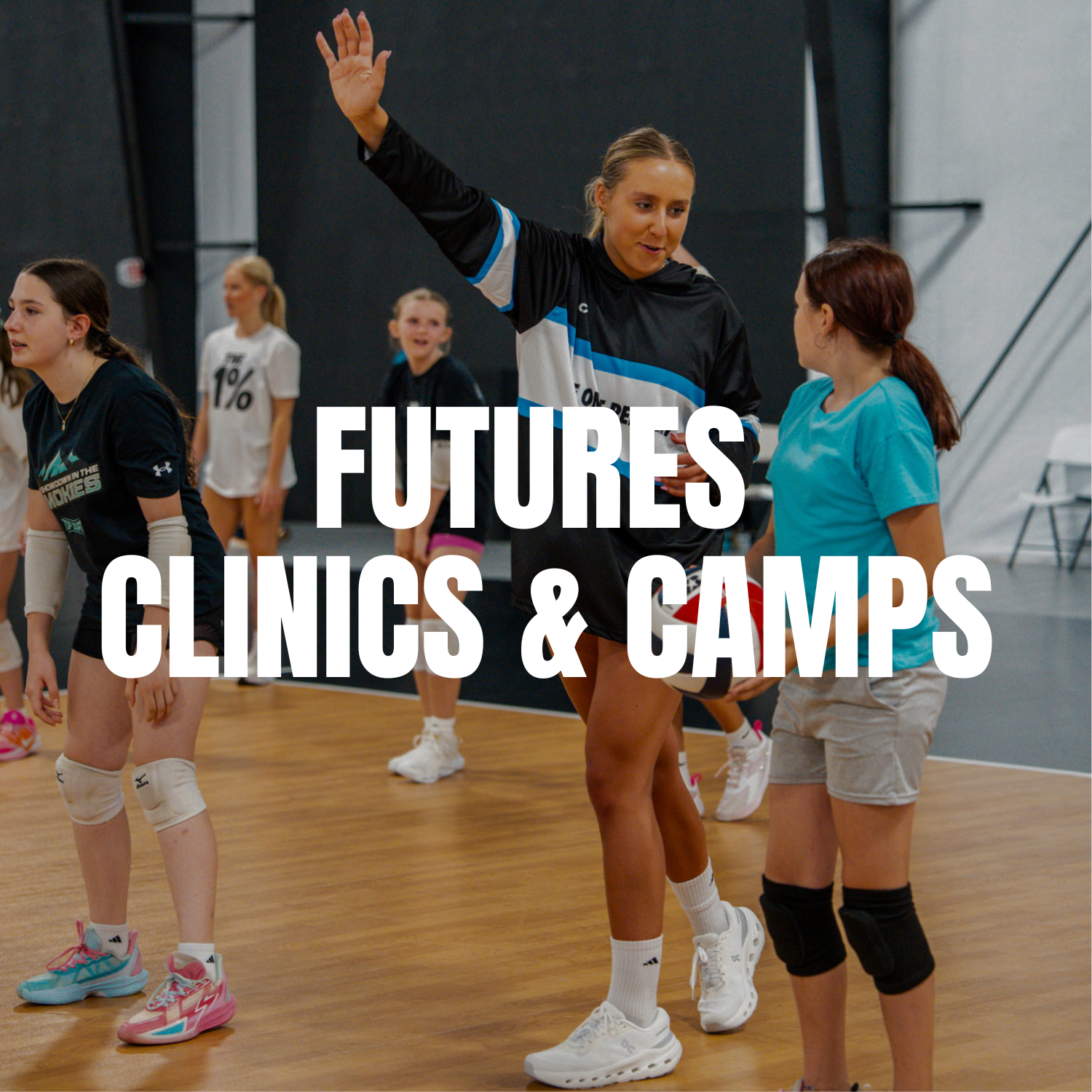 Group of young girls in sportswear practicing dance or cheerleading in a gymnasium with an adult instructor.