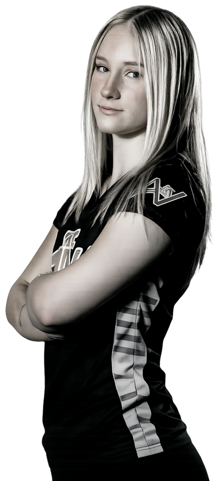 Young woman with blonde hair in a sports jersey, standing with arms crossed, posing confidently against a black background.