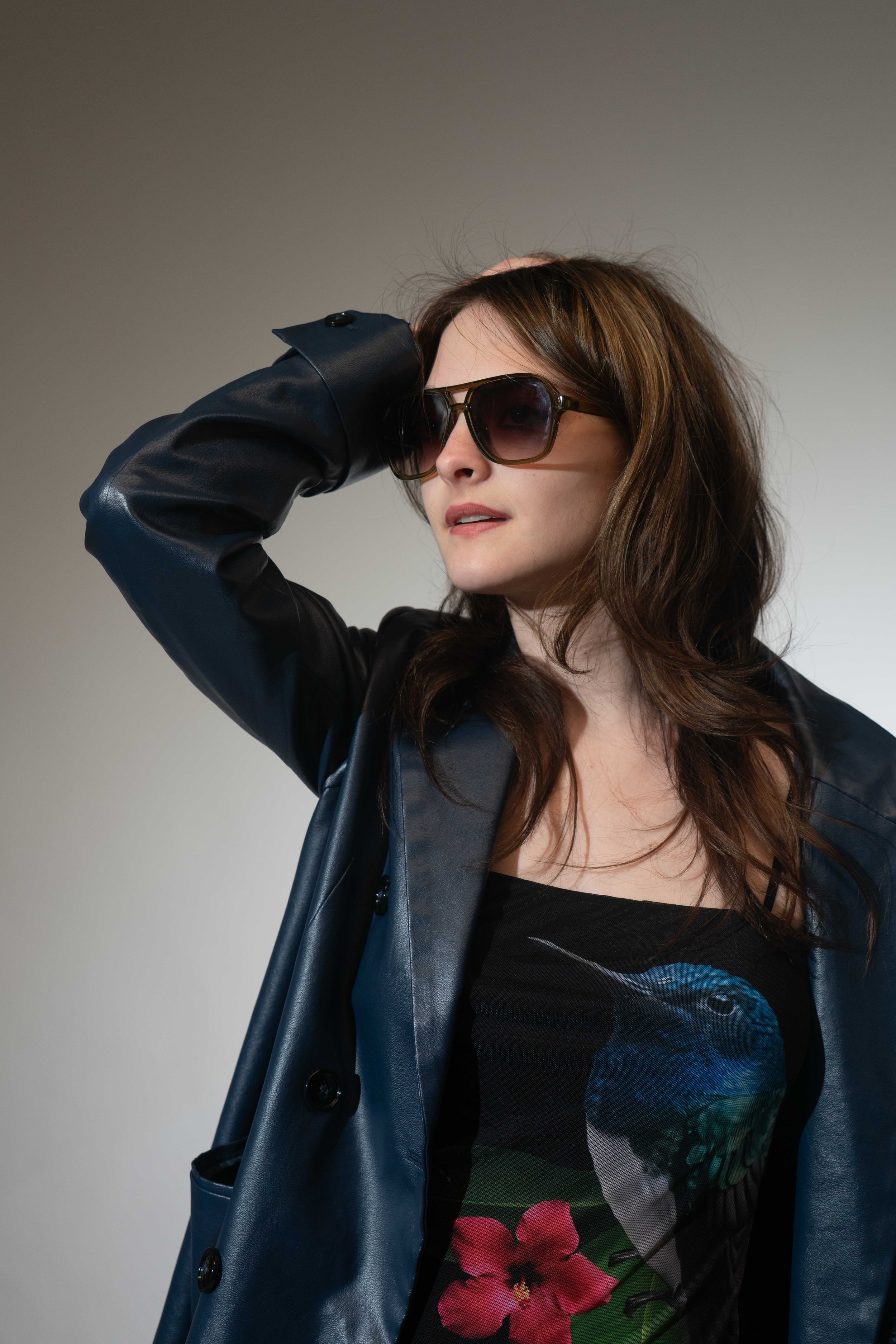 Image of actor Selina Piros is wearing sunglasses and a dress with a colibri on it