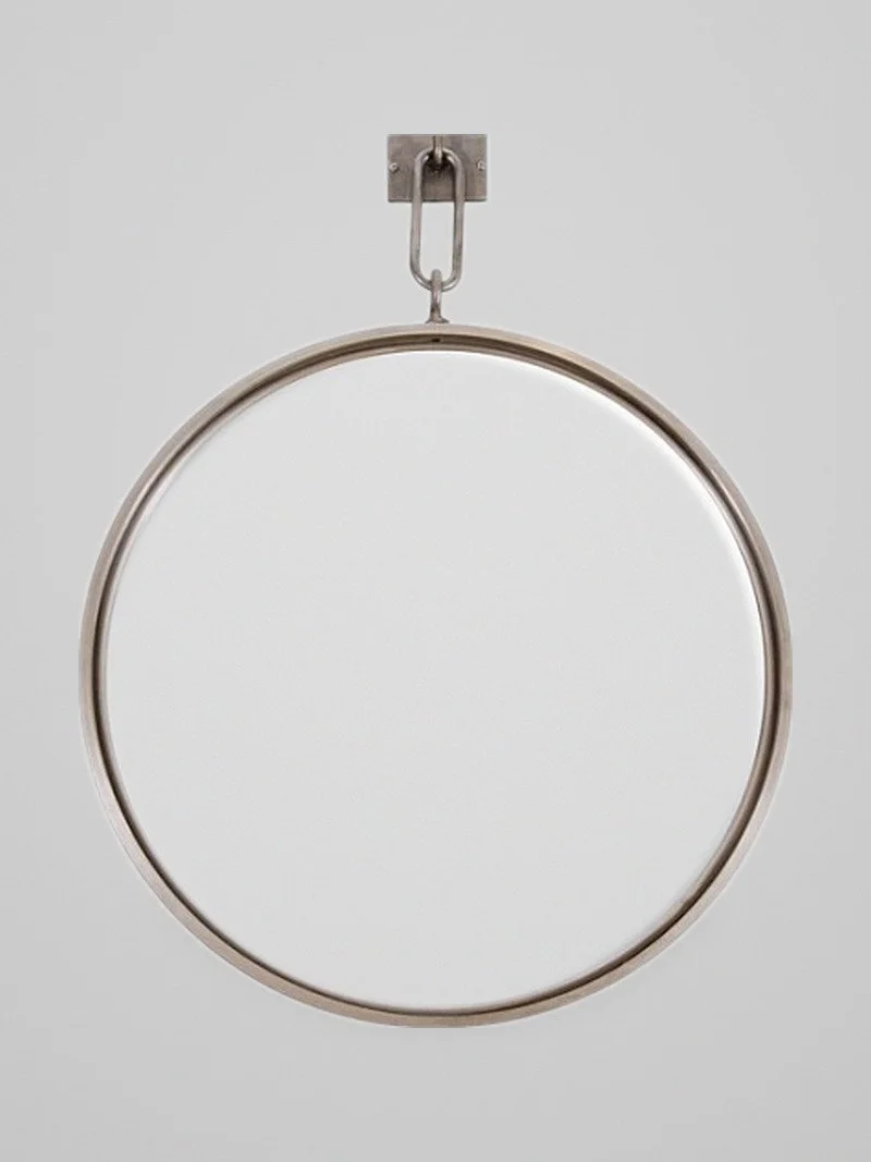 A Patinated Steel Circular Pendant Mirror
