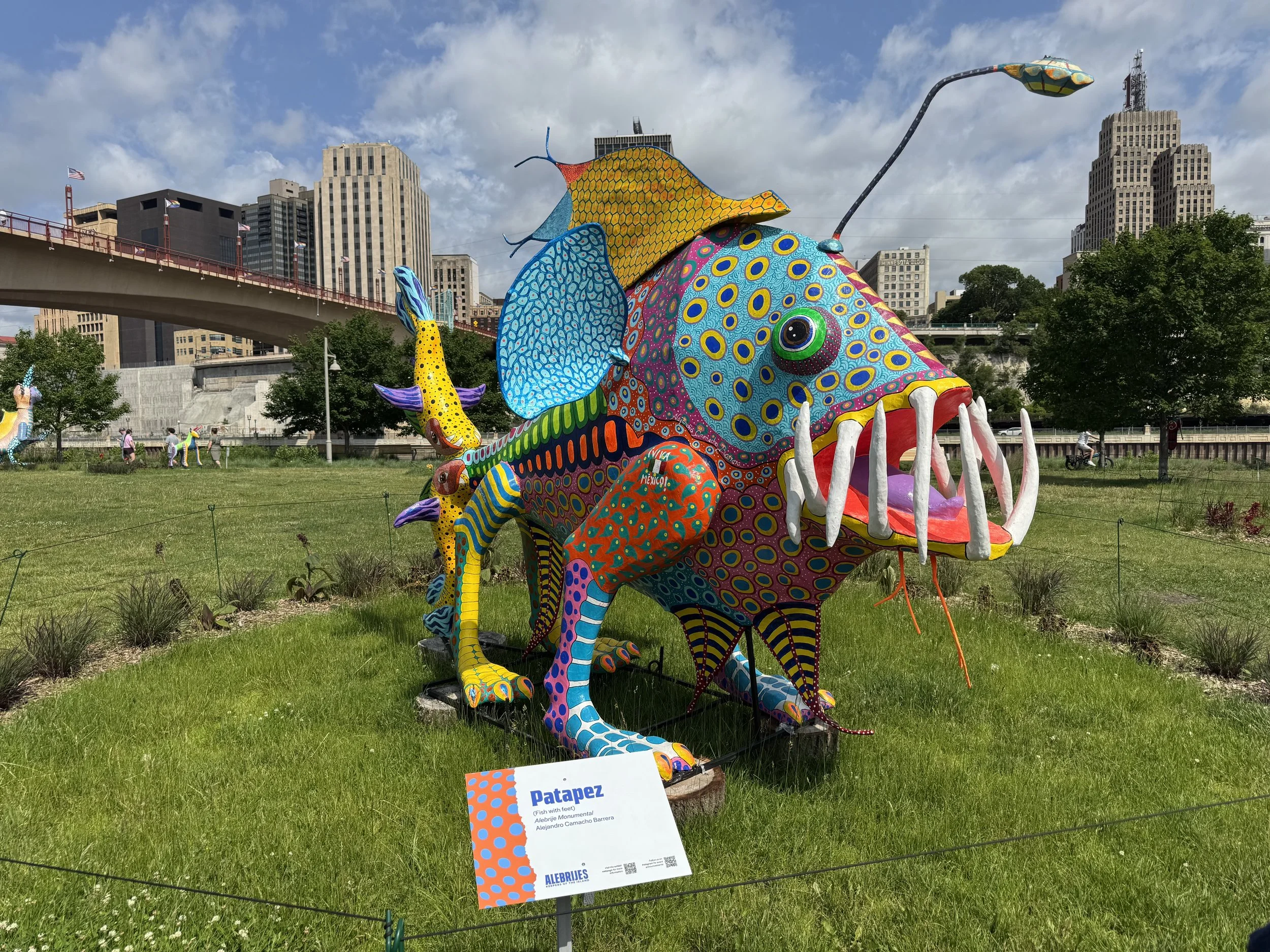 A 10 foot tall, multi colored sculpture featured as part of an Alebrije art installation at Raspberry Island Regional Park.
