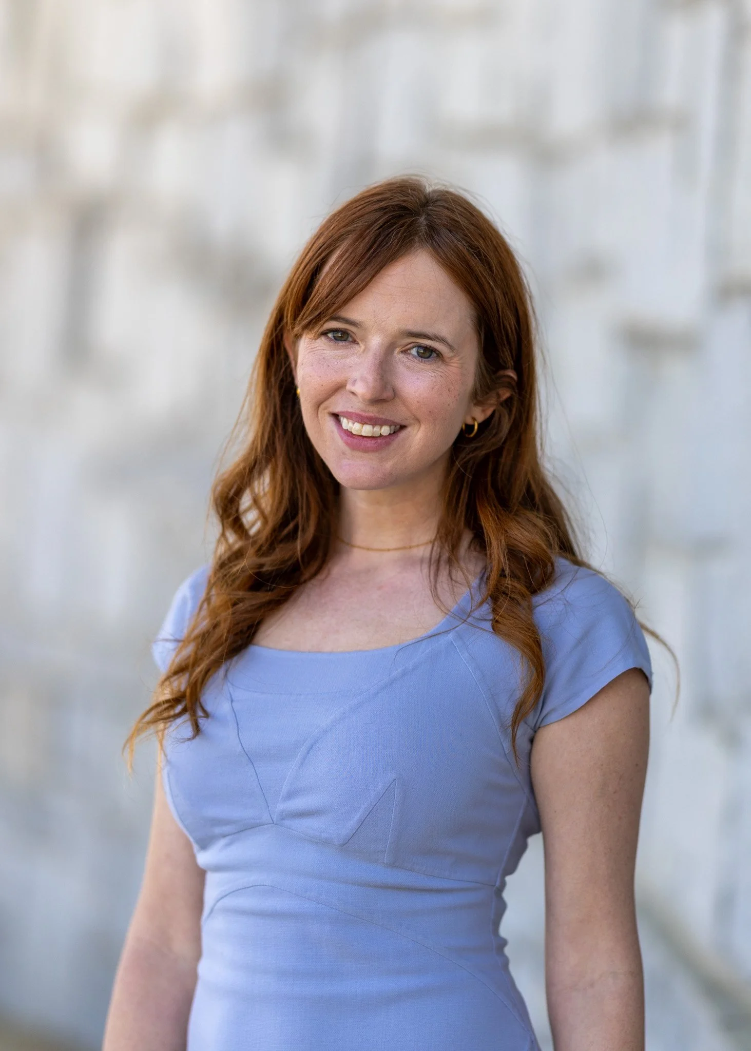 Mandy Conner, Principal Attorney at Conner Law Group, smiling outdoors with a blurred background.