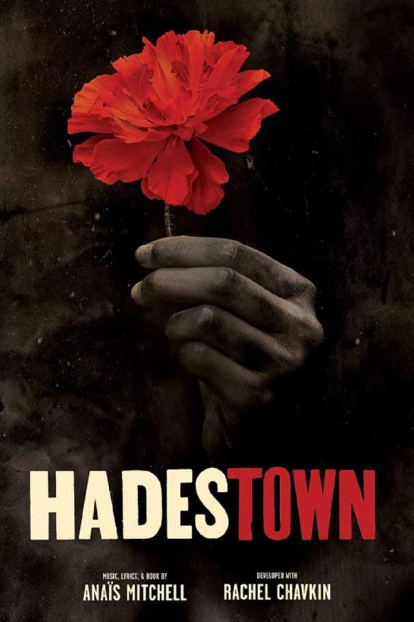 A hand holding a red flower against a dark background, with the title "Hades Town" at the bottom, along with the names Anaïs Mitchell and Rachel Chavkin.