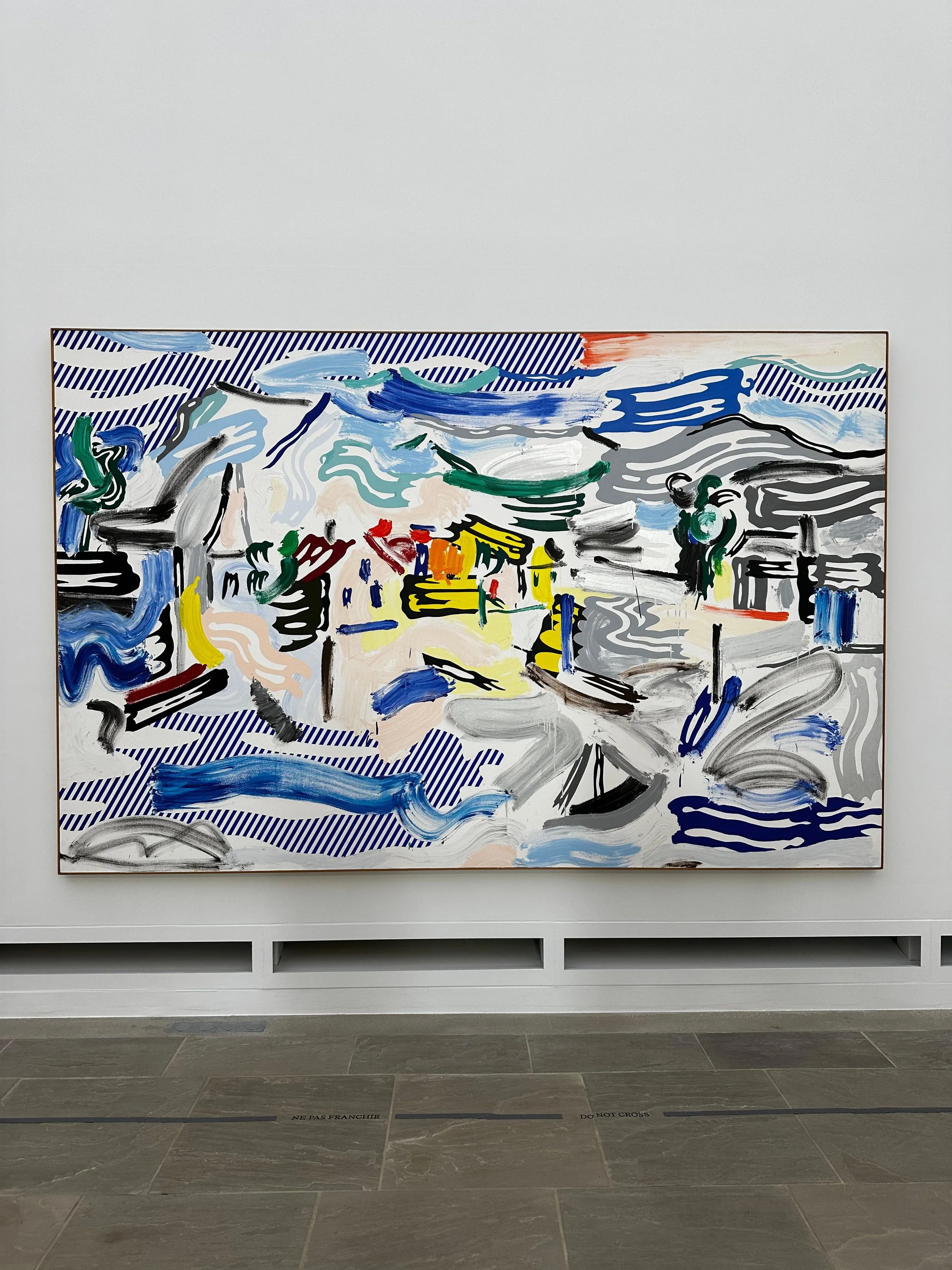 Large Roy Lichtenstein painting with bold blue, yellow and black brushstrokes featured in the Sea, Pop & Sun exhibition at Fondation Villa Carmignac.