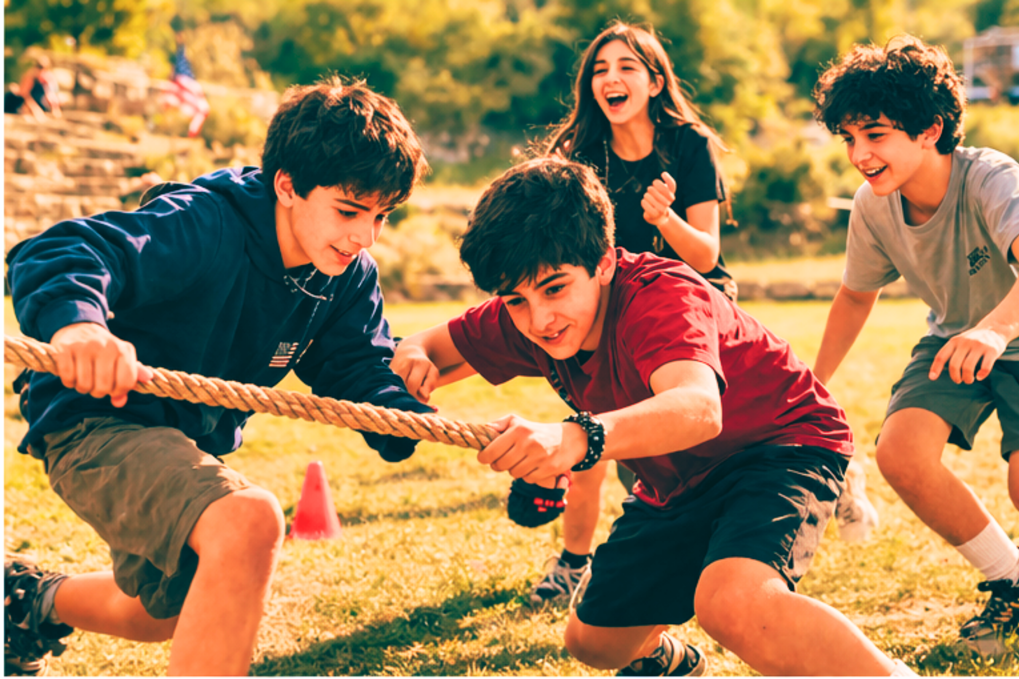 Group of children playing tug-of-war outdoors, kids smiling and enjoying the game in a sunny park setting.
