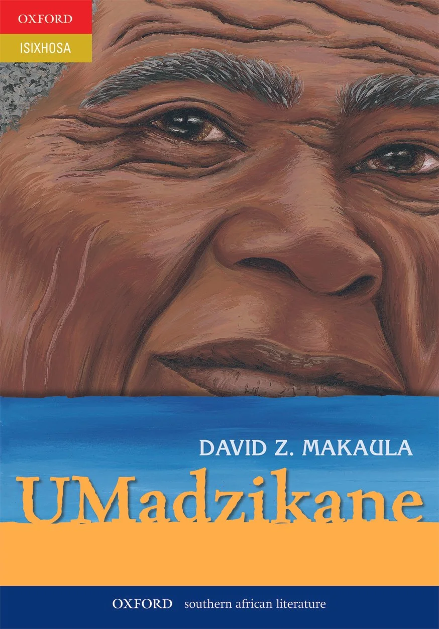 Close-up of a smiling elderly person's face on the book cover titled UMadiziane by David Z. Makaula, published by Oxford. The person has dark skin, expressive eyes, and gray eyebrows.