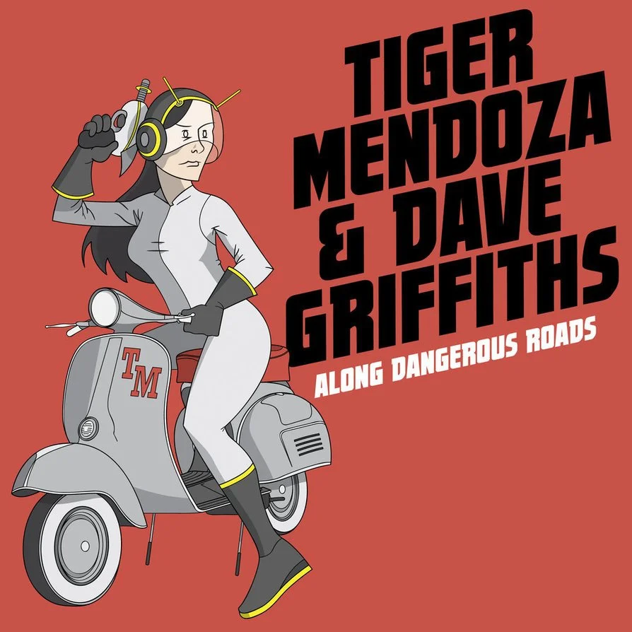 A cartoon woman wearing a white jumpsuit, black gloves, yellow accents, and a helmet with antennae, sitting on a gray scooter with a 'TM' logo. The background is red with bold black and white text reading 'Tiger Mendoza & Dave Griffiths Along Dangero