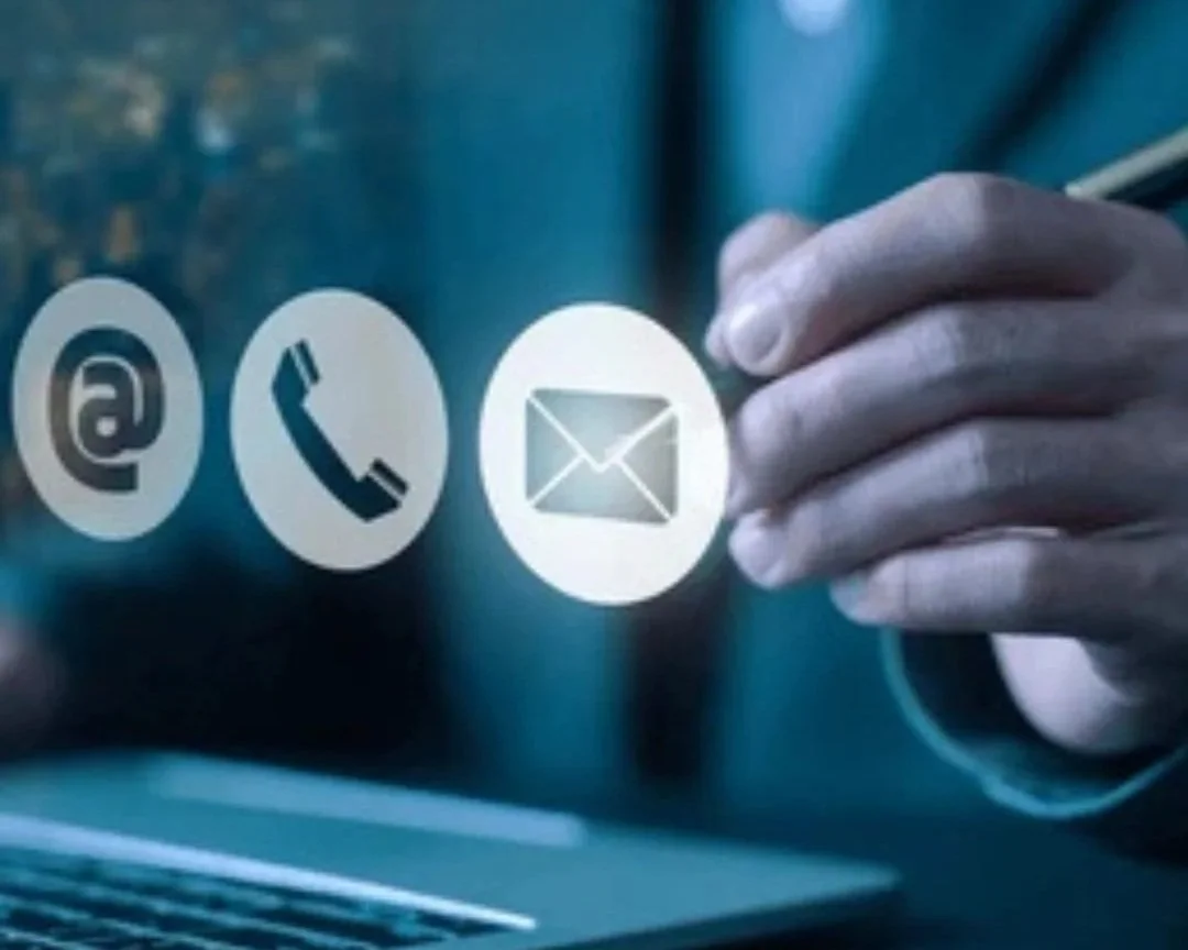 Digital graphics of contact icons: email, phone, and mail, with a hand reaching towards the email icon.