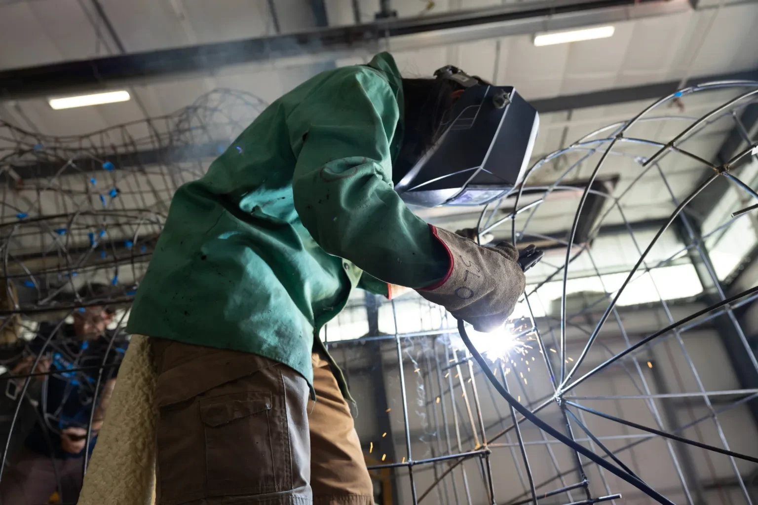 Erin Wang welds the final sections of the float’s frame before it is covered, as another student behind her prepares the next section to ensure the float is fully prepared for transport to Pasadena.